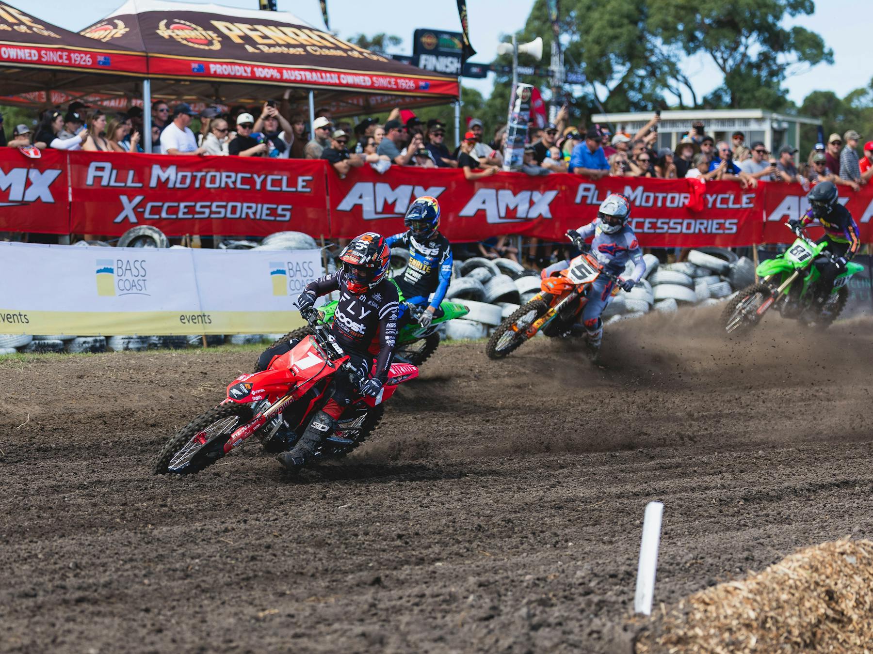 A group of motocross riders turn a corner