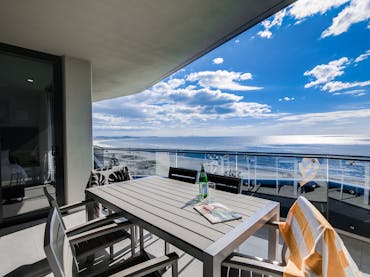 ocean front apartments with beach views and table for outdoor meals