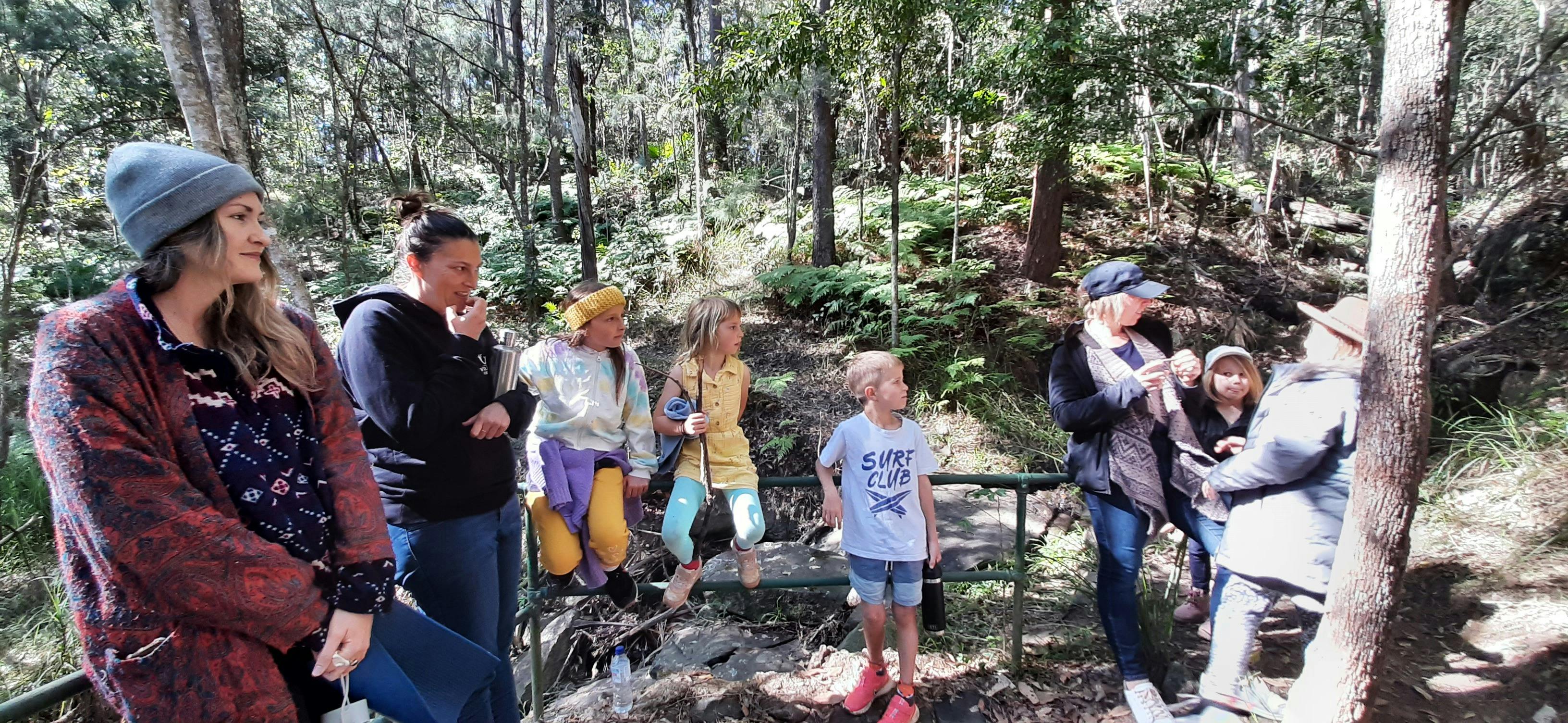 Young people and their parents gathered in a forest