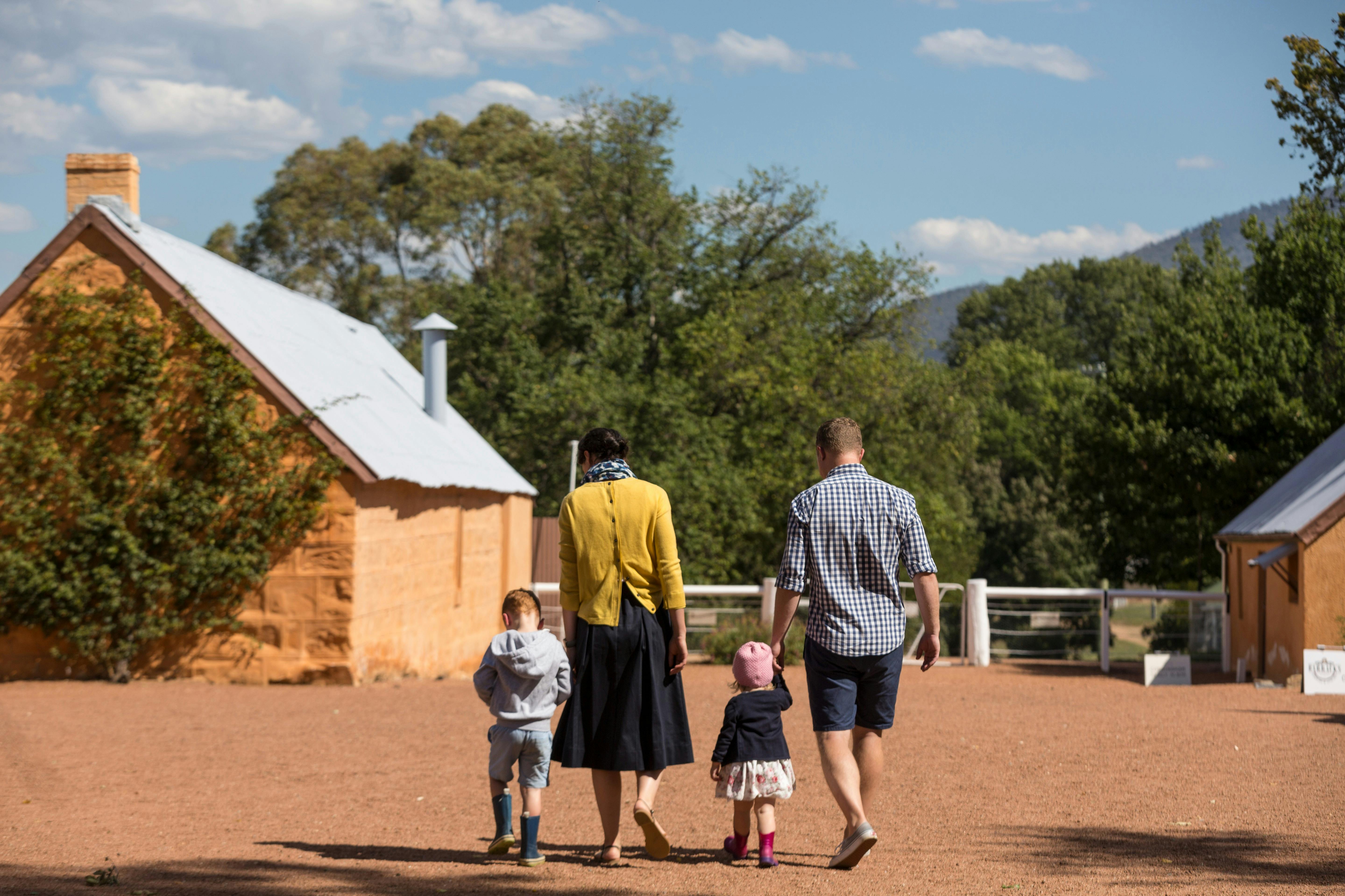 family walking in Lanyon courtyard surrounded by heritage buildings
