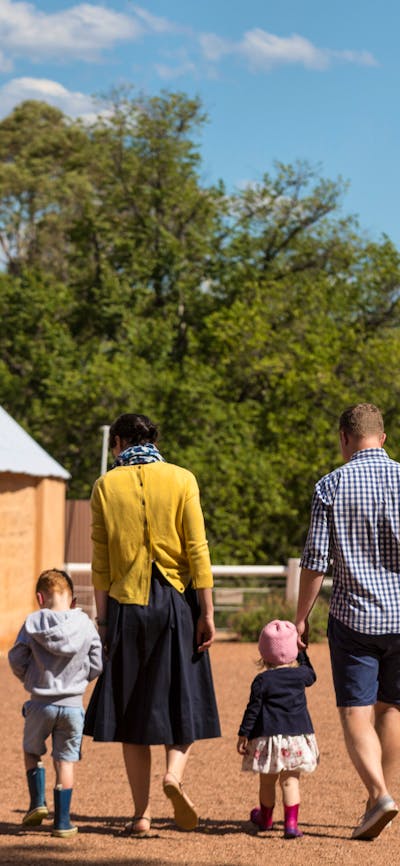 family walking in Lanyon courtyard surrounded by heritage buildings