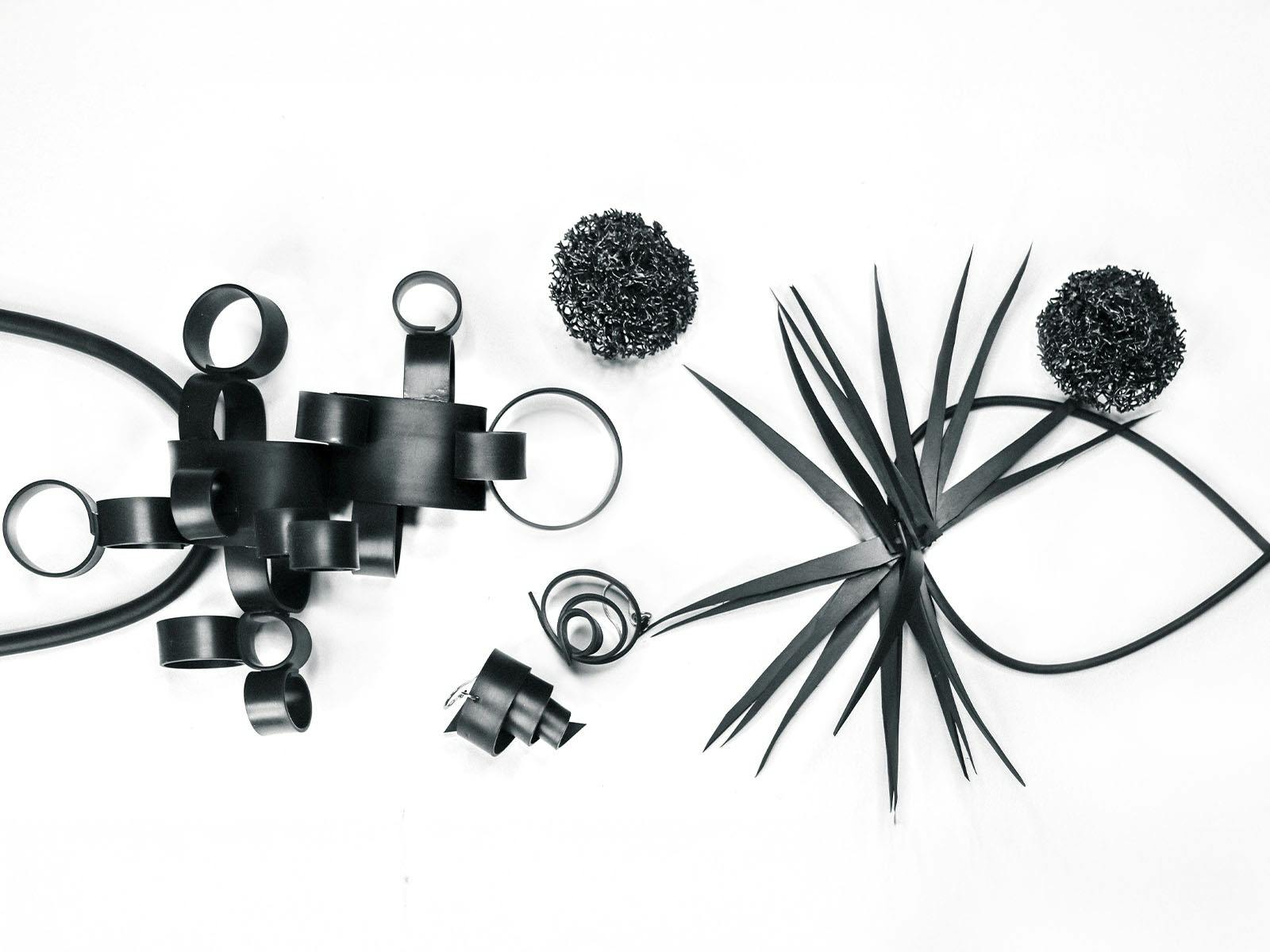 Jewellery made out of black rubber in abstract forms