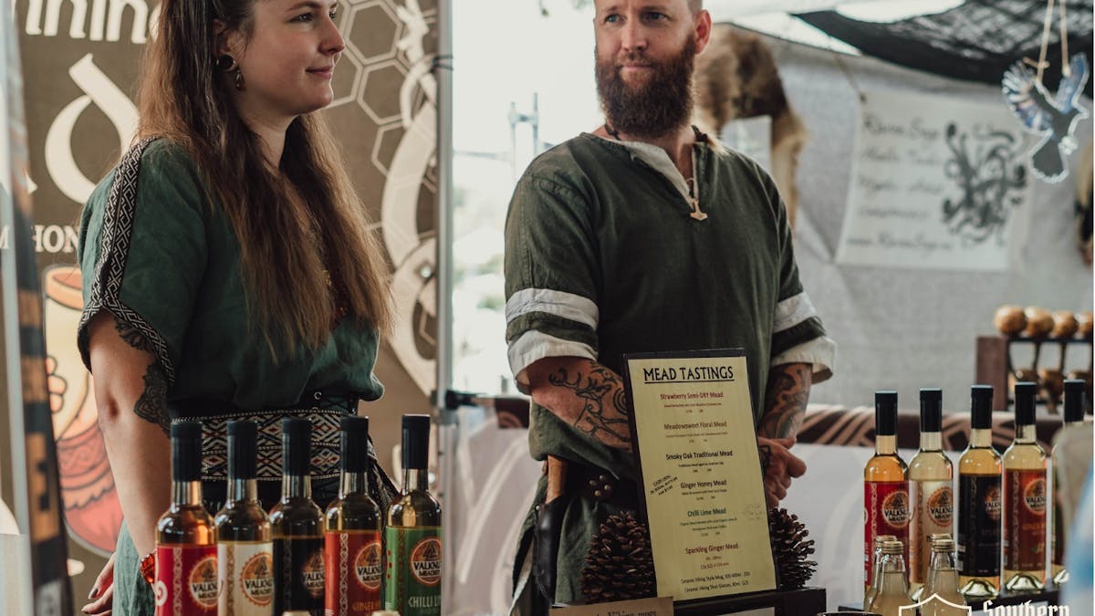 Valknut Meadery stallholders offering traditional tastings at Southern Realm Festival.
