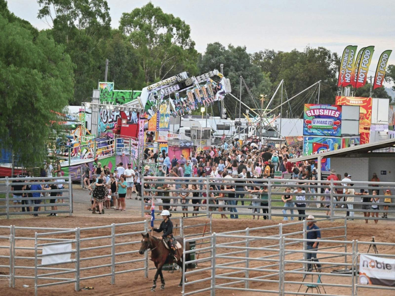 Crowds enjoying the Mudgee Show with sideshow attractions and arena events at Mudgee Showground.