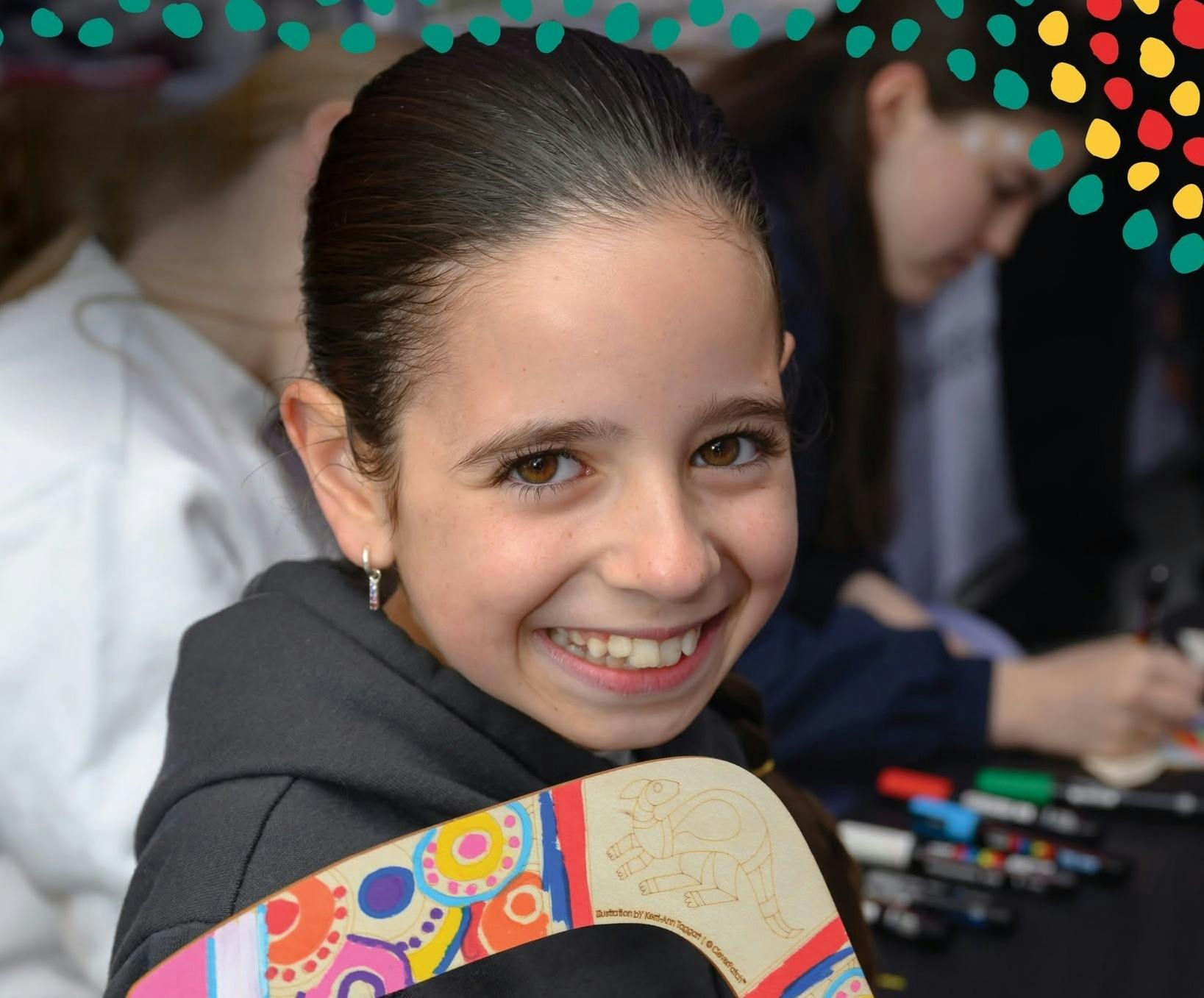Child creating artwork on a boomerang
