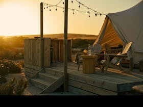 Luxury glamping deck with wine and grazing board overlooking Port Neill dunes