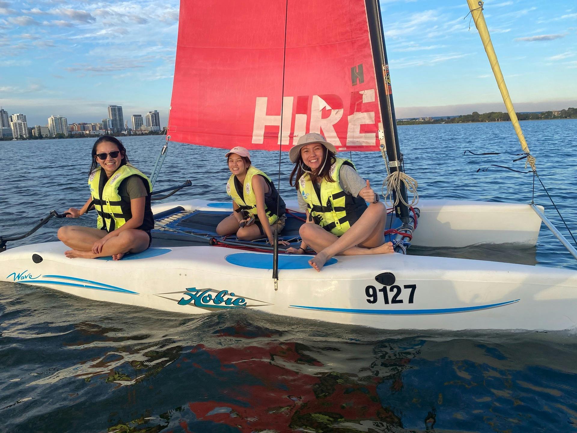 Three people sailing on a Hobie catamaran on the Swan River!