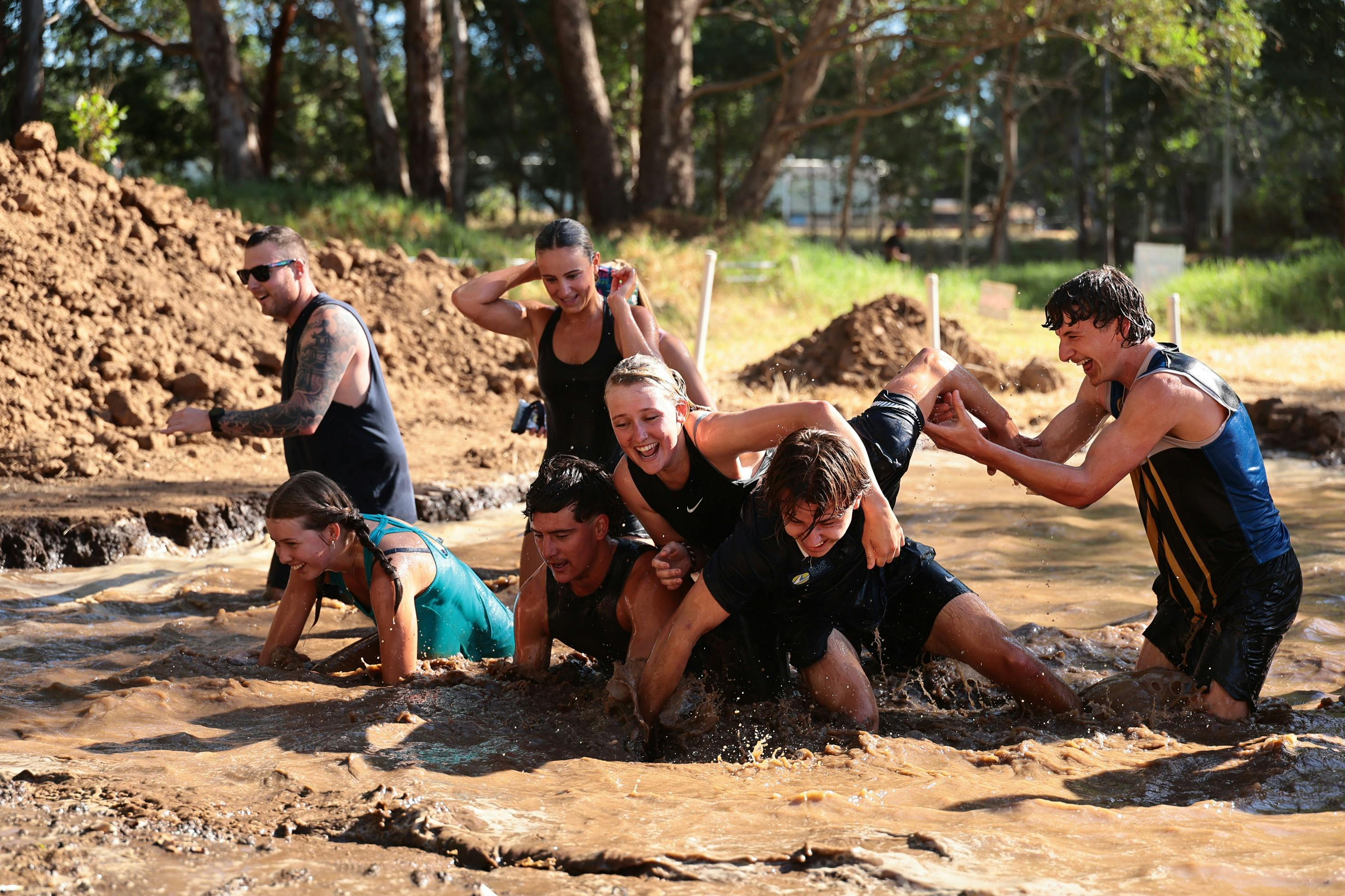 Friends playing in the mud pit