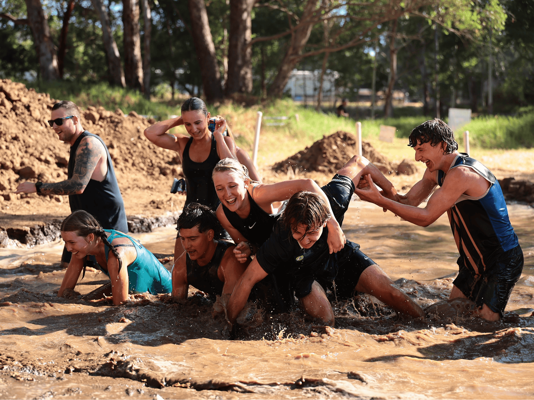 Friends playing in the mud pit