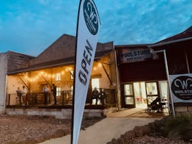 Brewery entrance lit at night time
