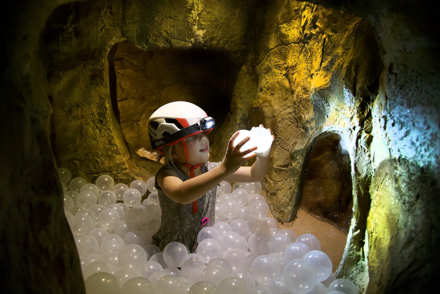 Young child playing with ball in the indoor caving facility at Sunshine Coast Recreation Precinct