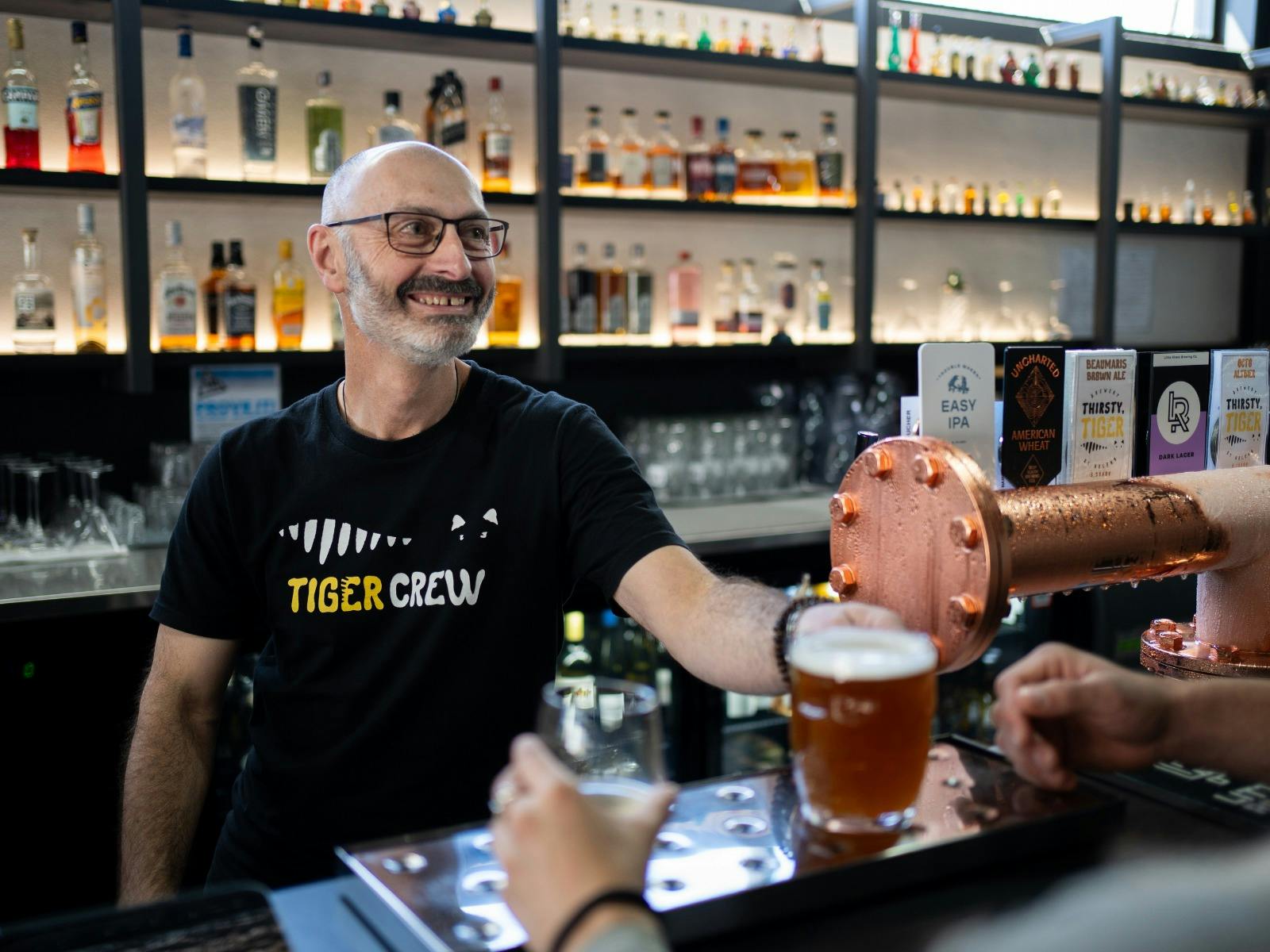 Brewer pouring Thirsty Tiger beer at Easy Tiger, St Helens.