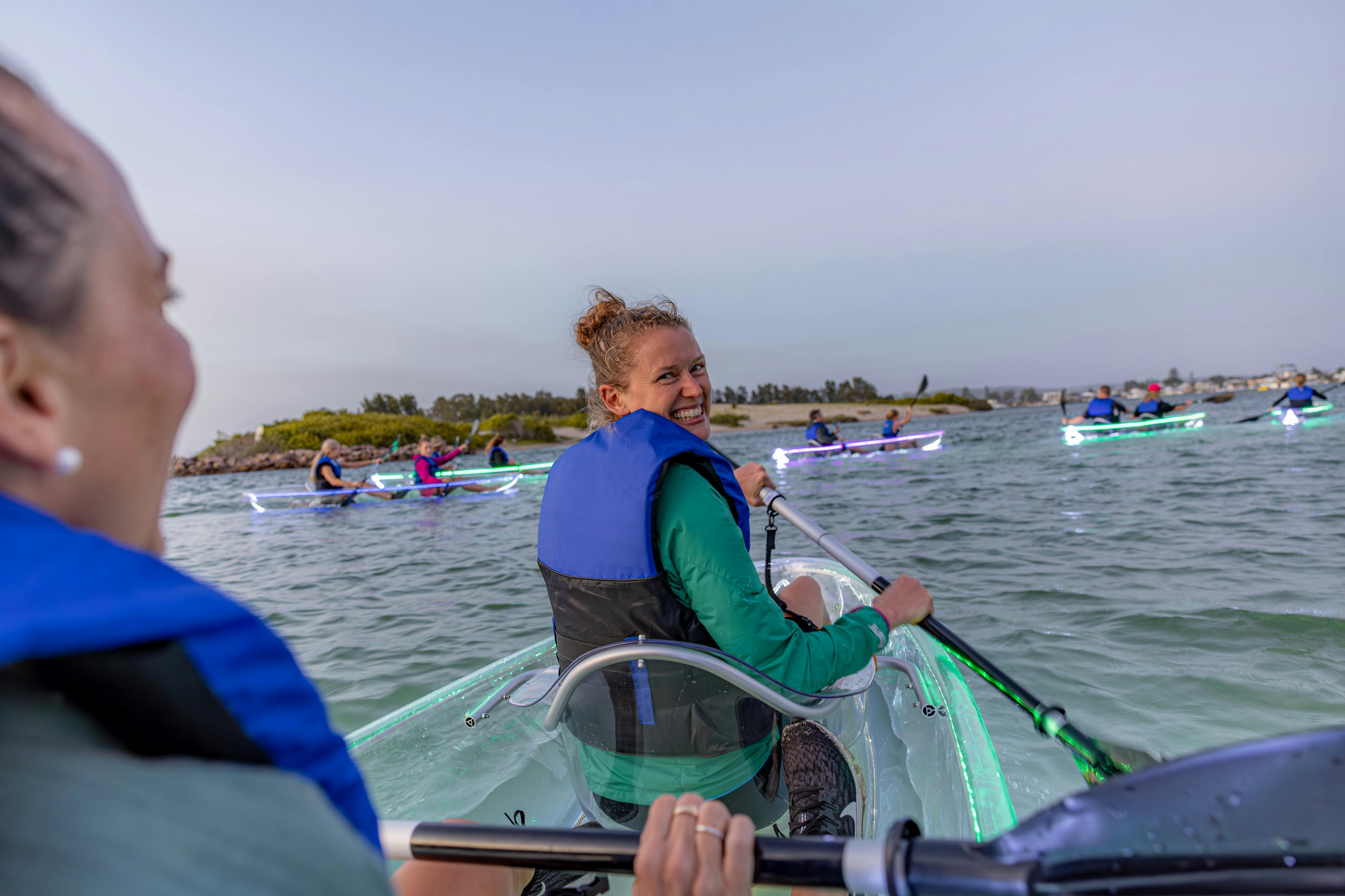 Two ladies in double clear kayak.