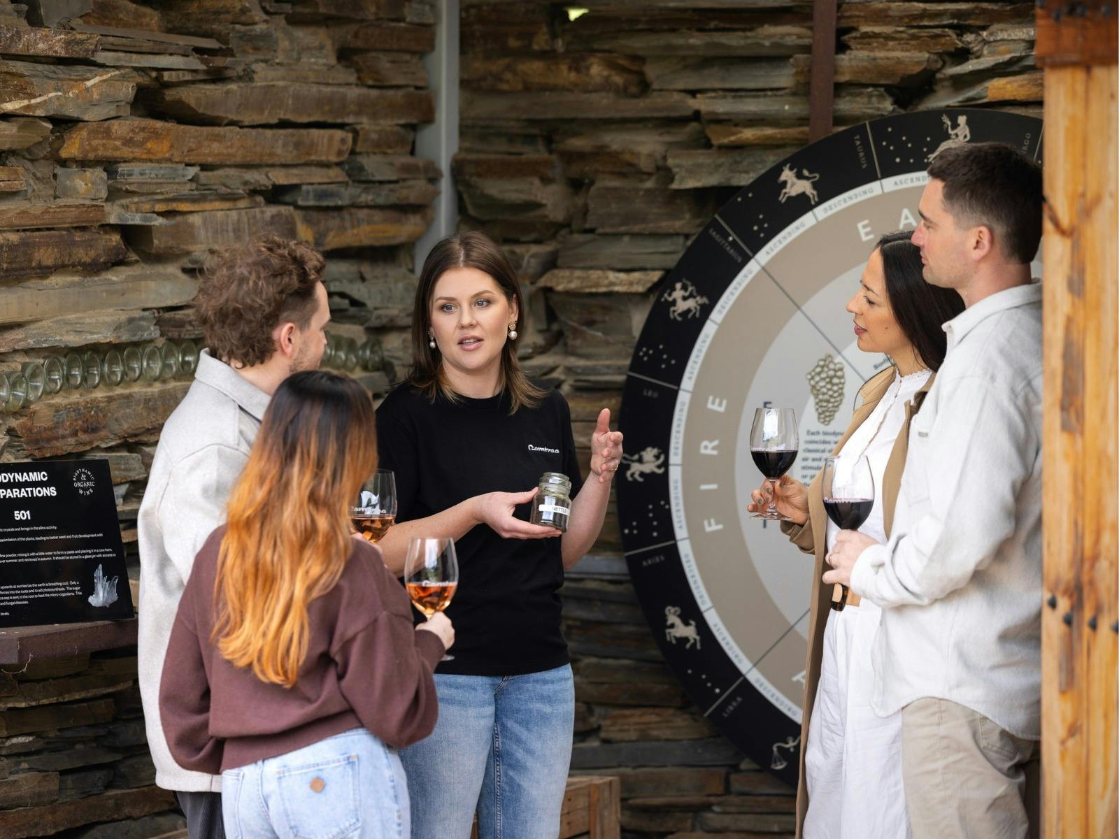 Gemtree staff member talking to customers holding glasses of wine