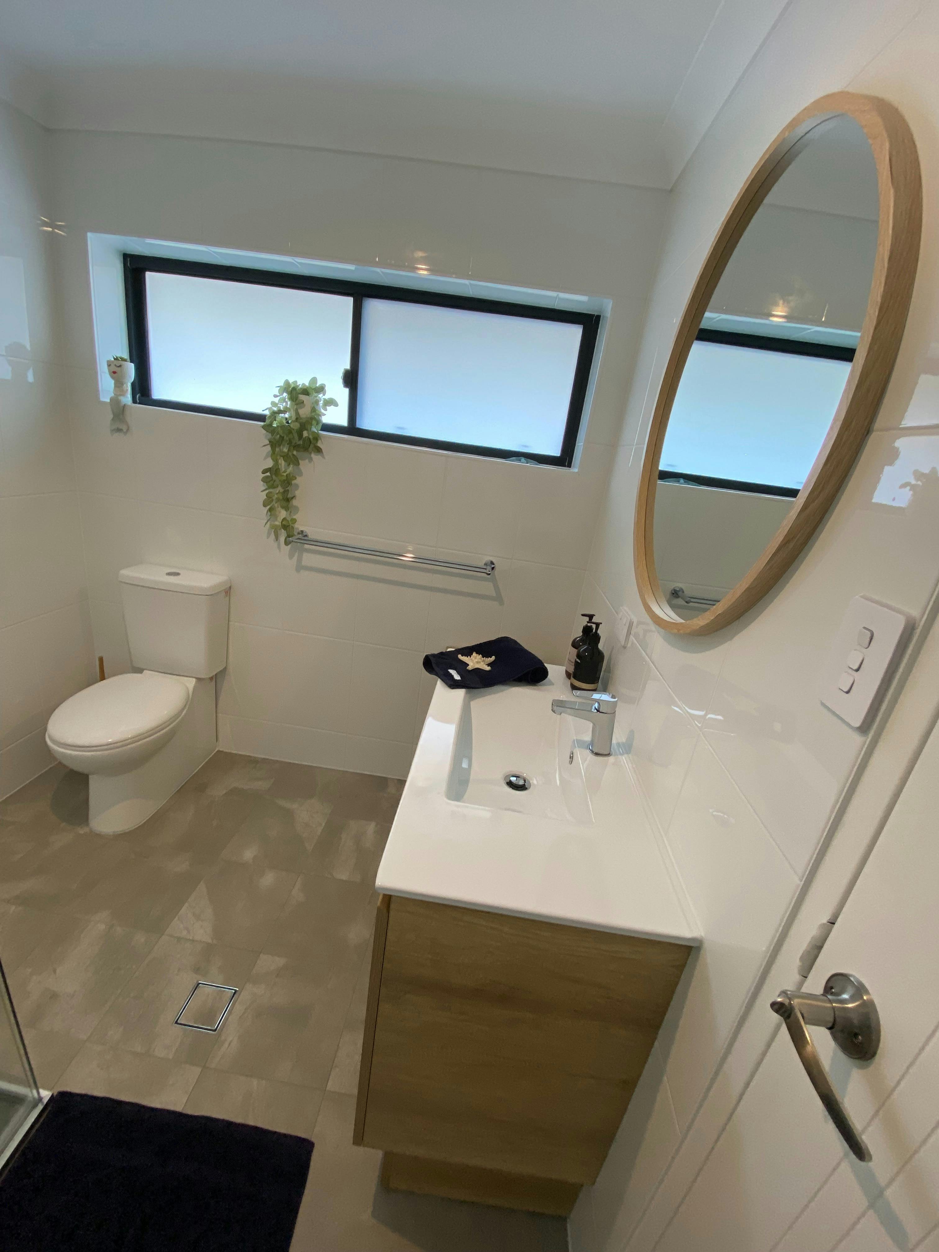 bathroom vanity, toilet and modern double shower
