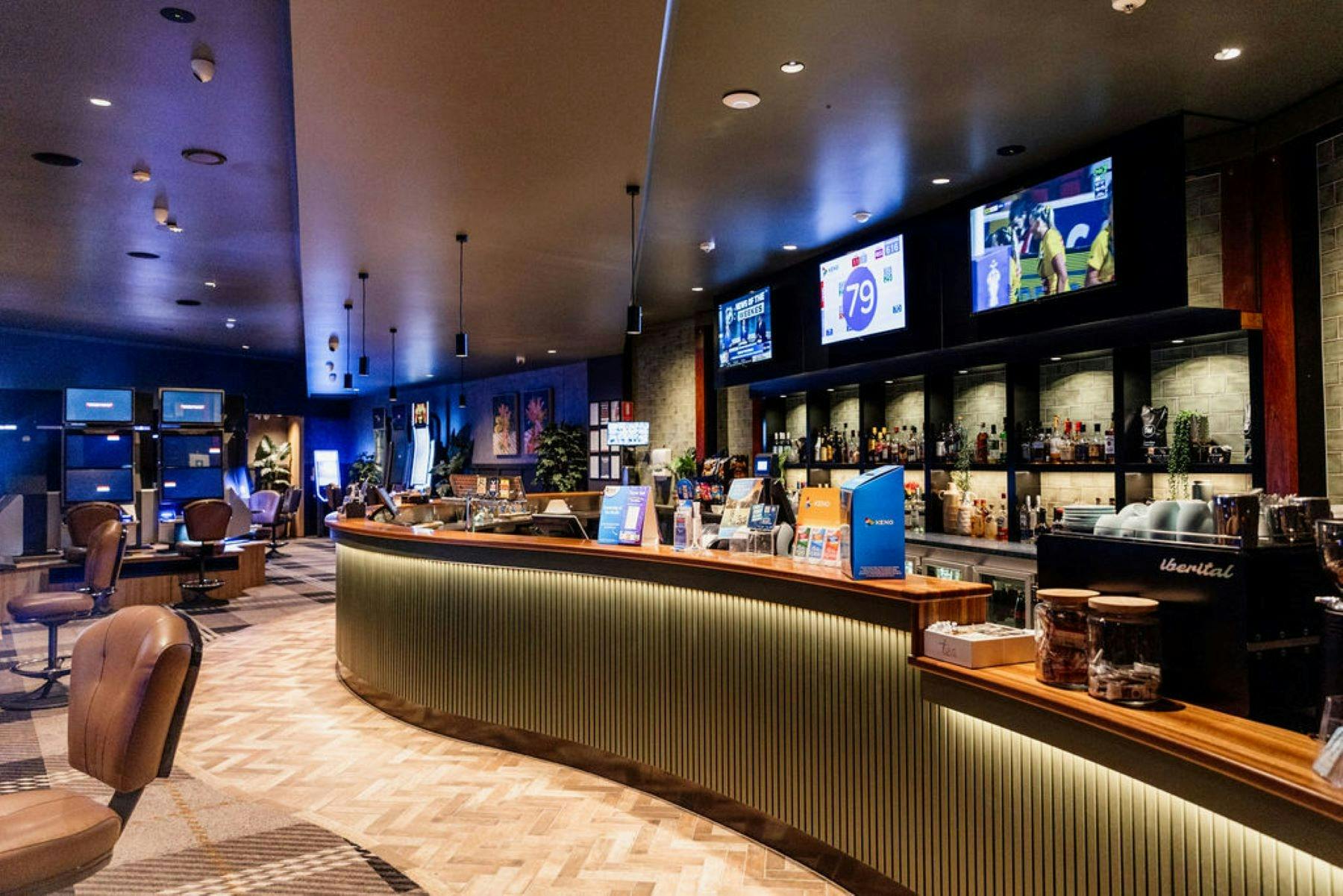 Photo shows a sleek, modern bar in a comfortable gaming lounge.