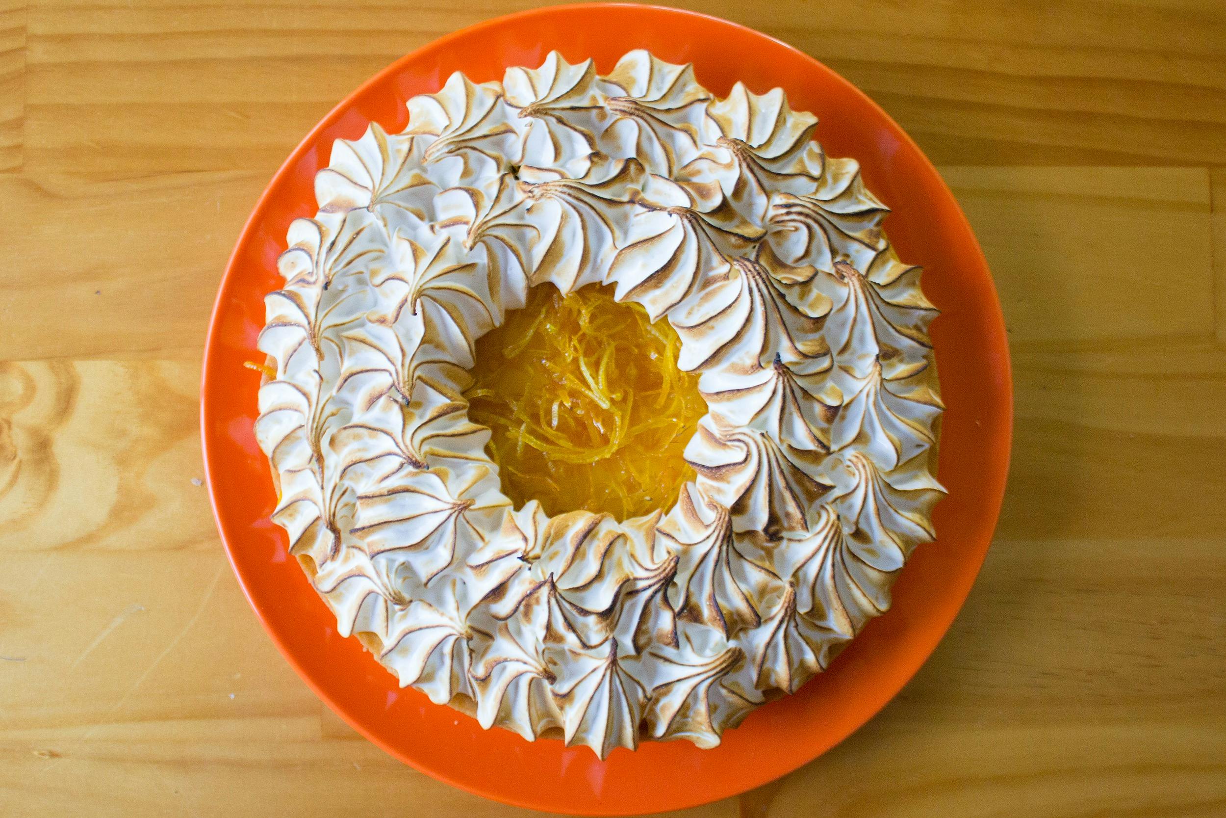 Lemon Meringue tart on a orange plate in the Jacican cooking class studio in Mirboo North, Gippsland