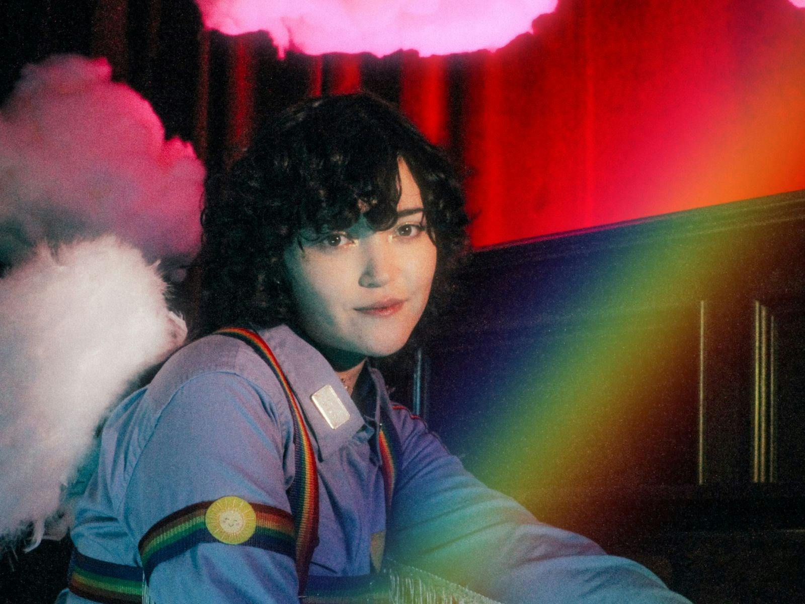 Performer sitting under a rainbow