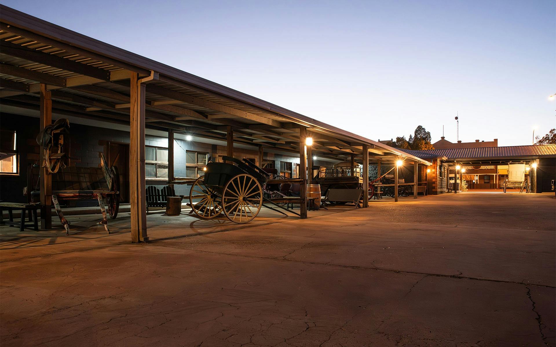 The Stables courtyard with vintage vehicles at night