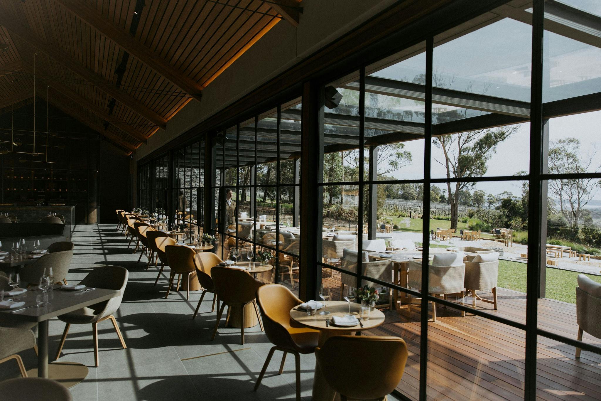 dining table and chairs inside the restaurant with views over the vineyard