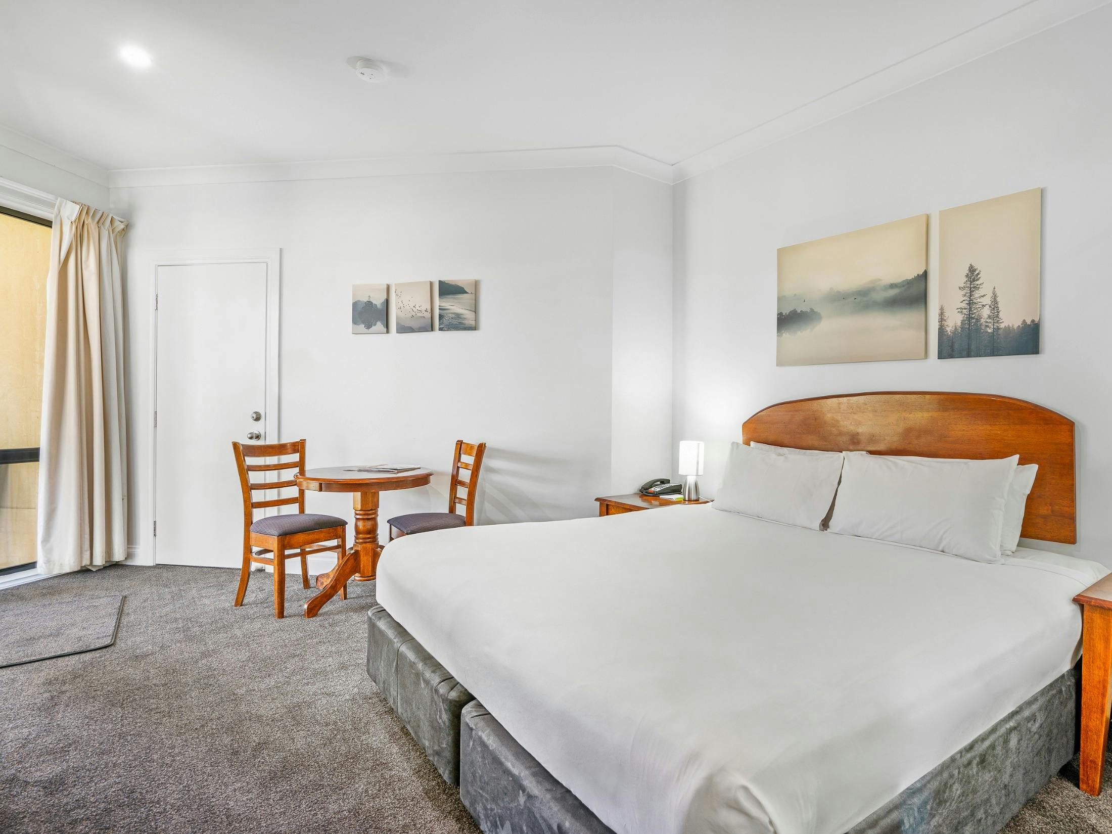 Bedroom with king bed, bedside tables and neutral decor