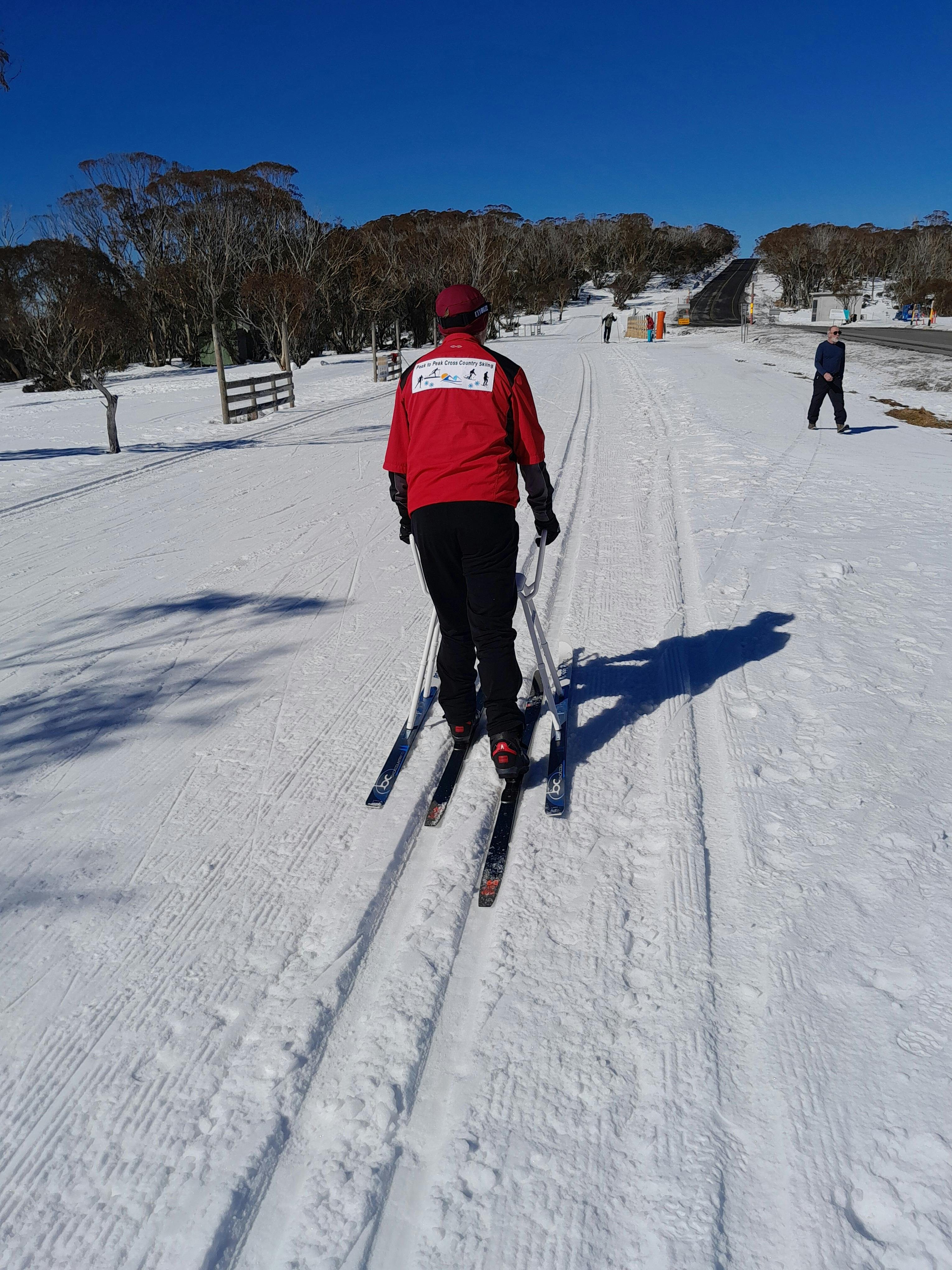 Man skiing with support equipment