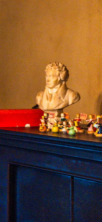 Calthorpes House mantlepiece with image of Dawn Calthorpe, small sculptures and Christmas ornaments
