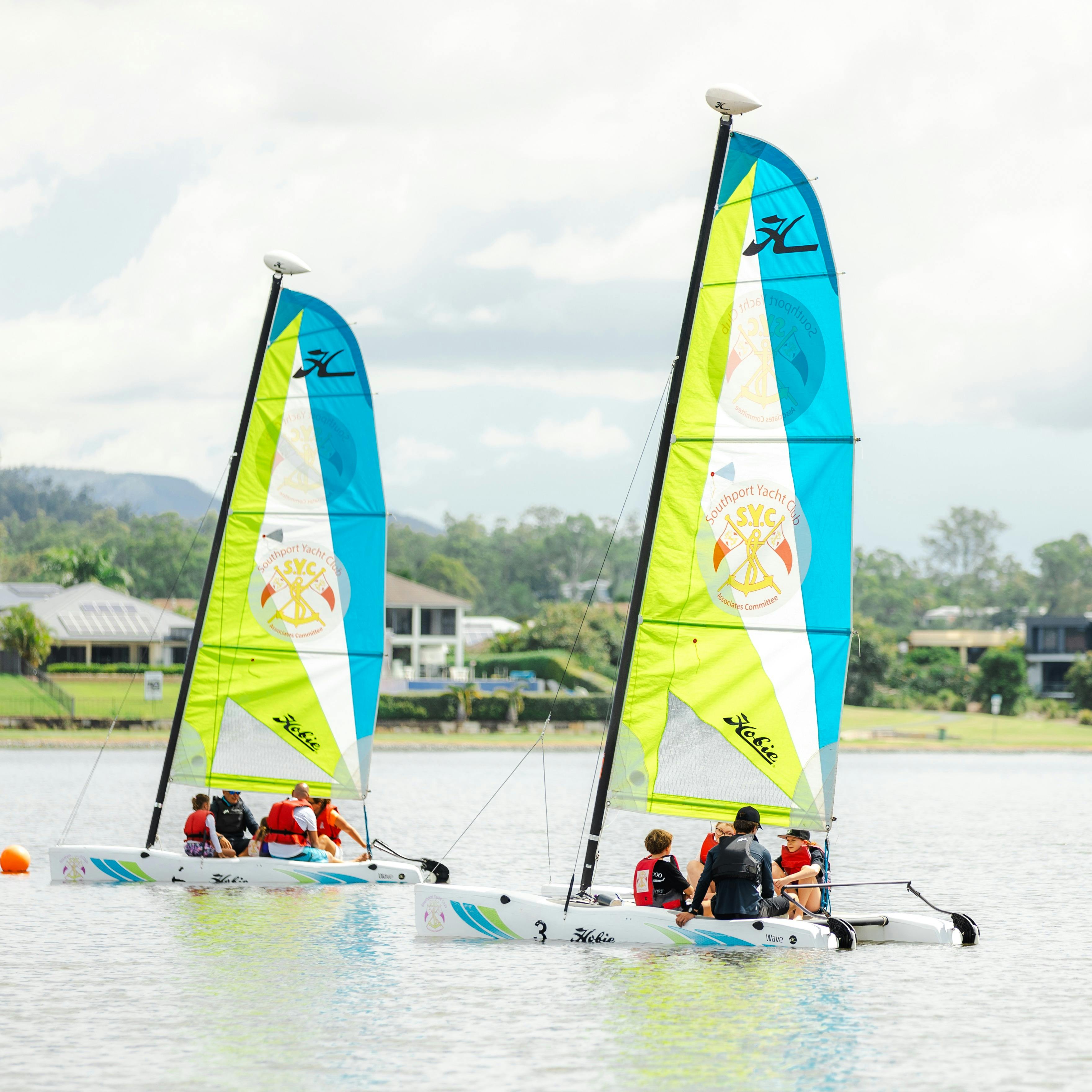 2 Sail Boats on the lake with families