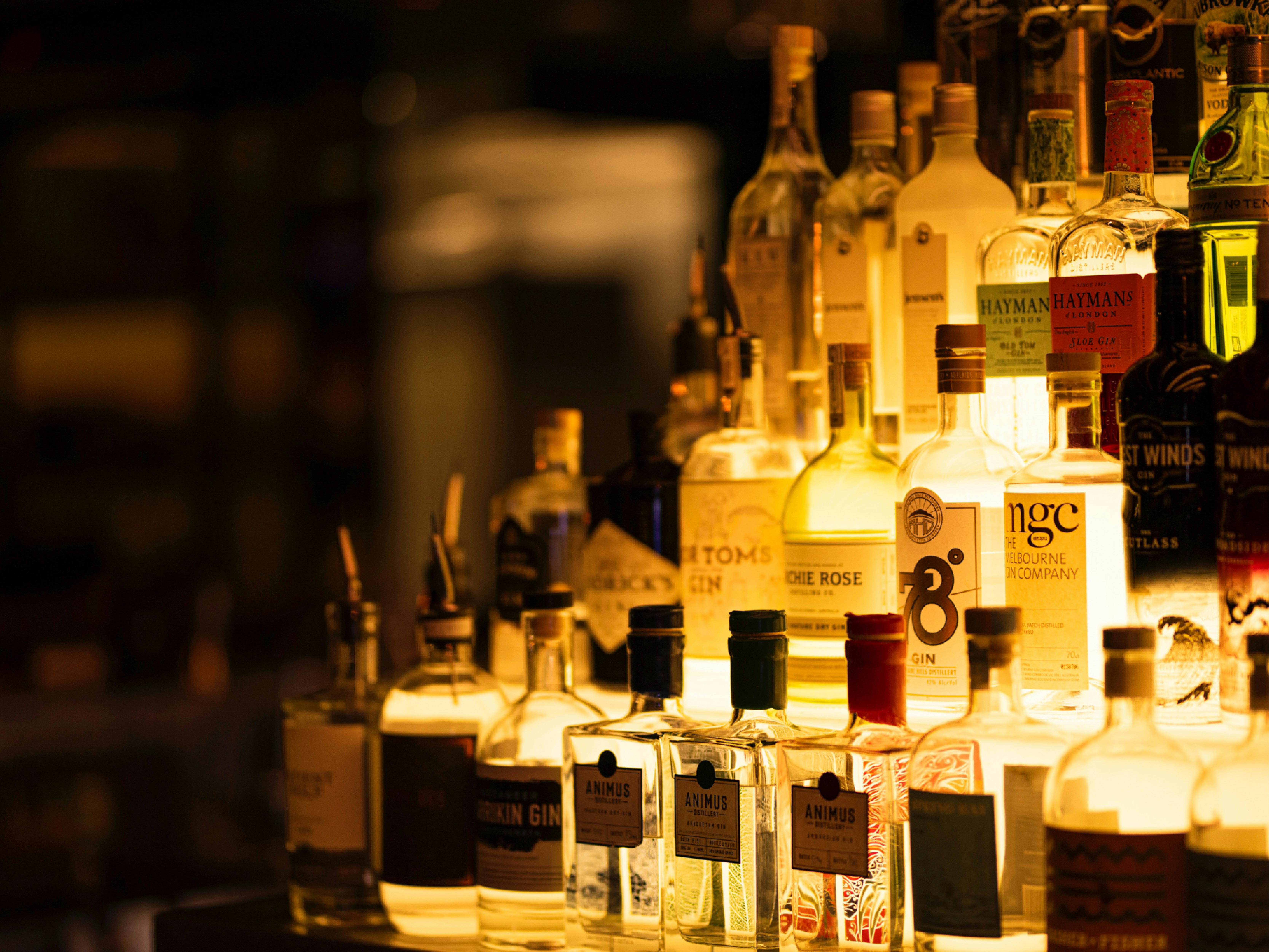 Whisky bar with a collection of bottles lit up with a backlight