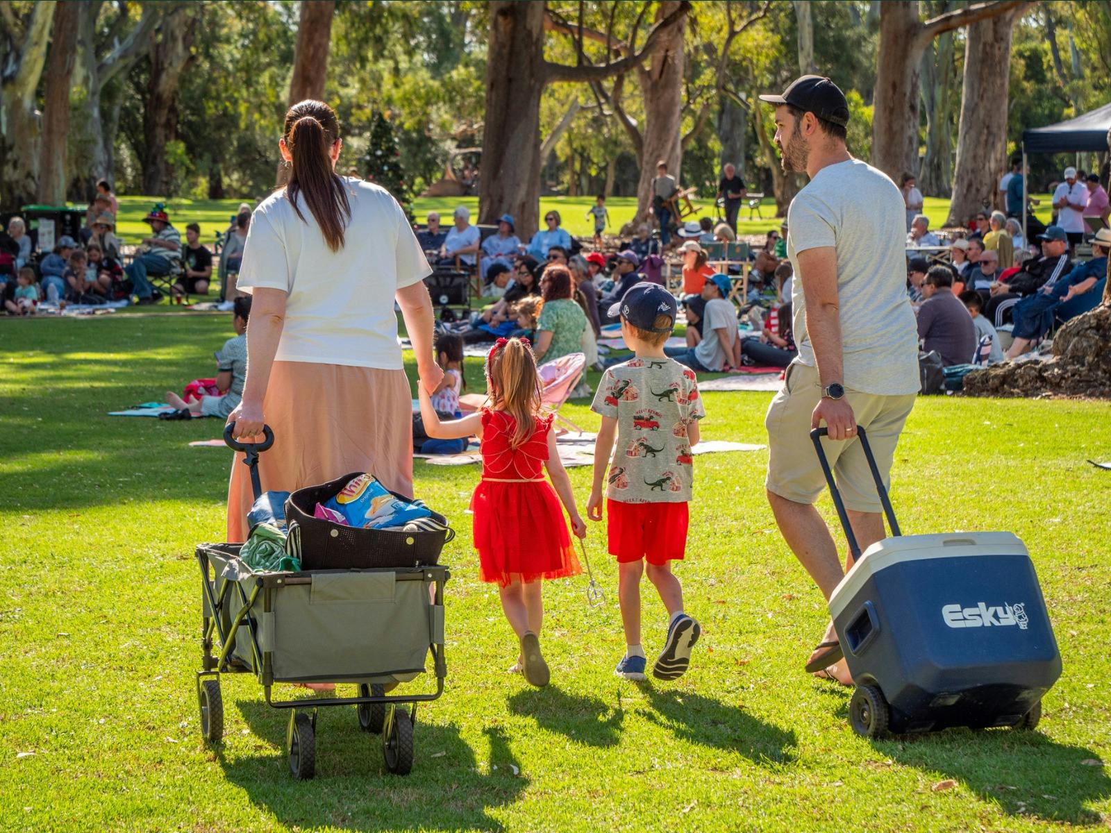 Image of a young family attending Carols in the Park