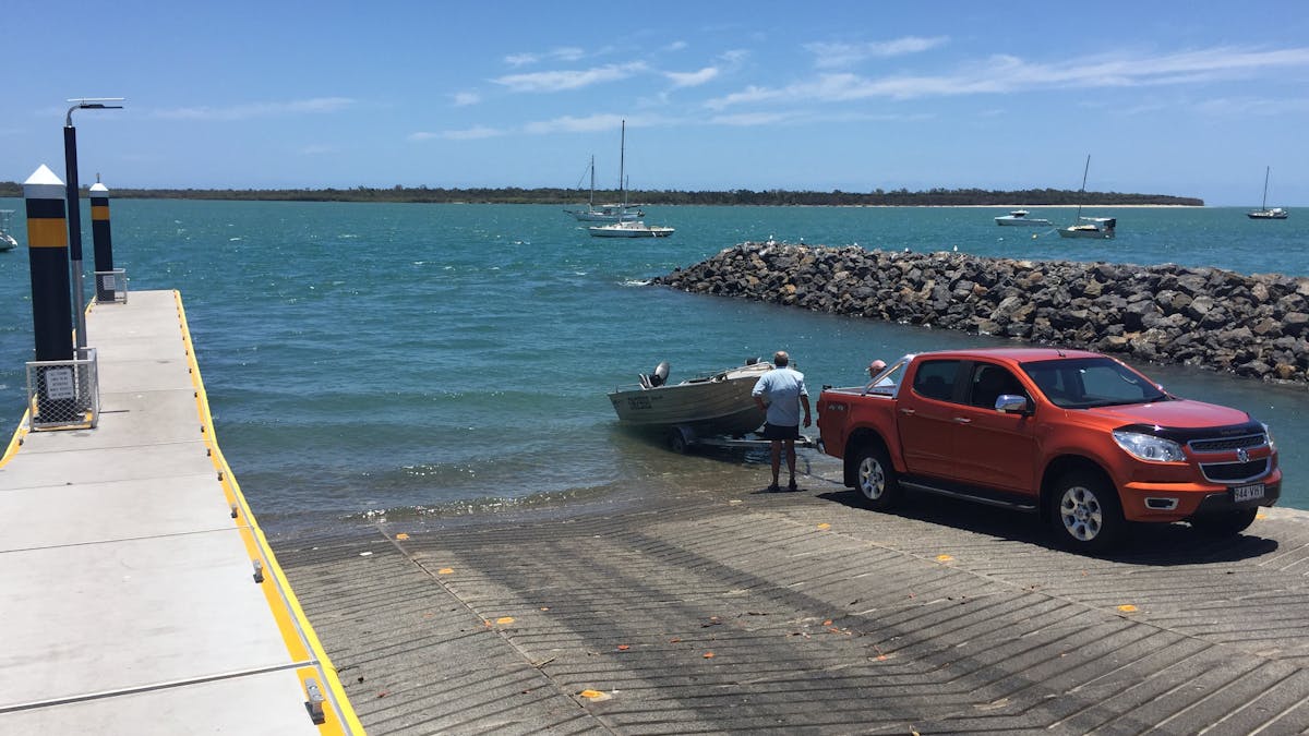 photo showing a vehicle on the Burrum Heads boat ramp launching a small aluminium boat.