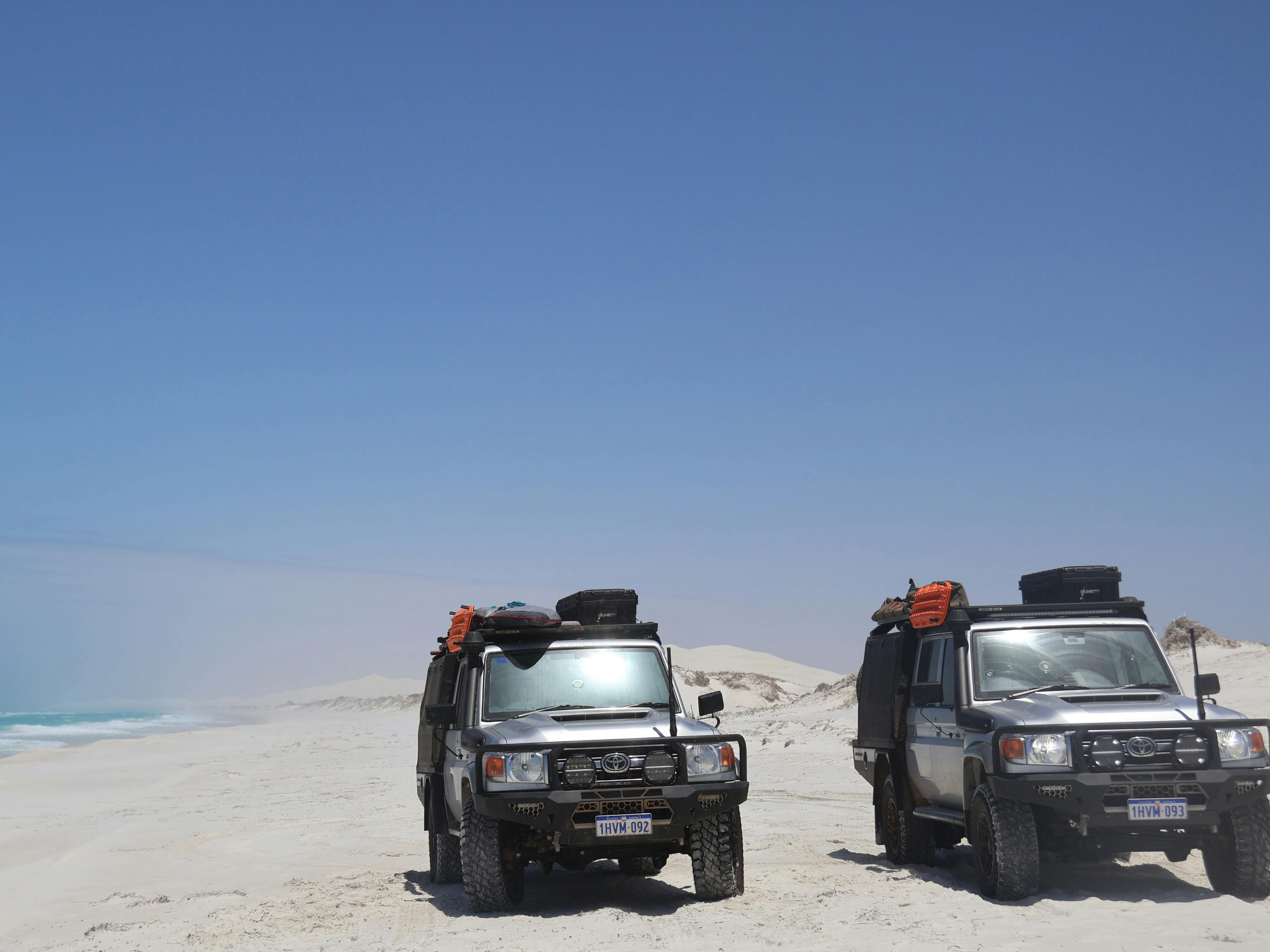Two land cruisers on the beach below the Bilbunya dunes