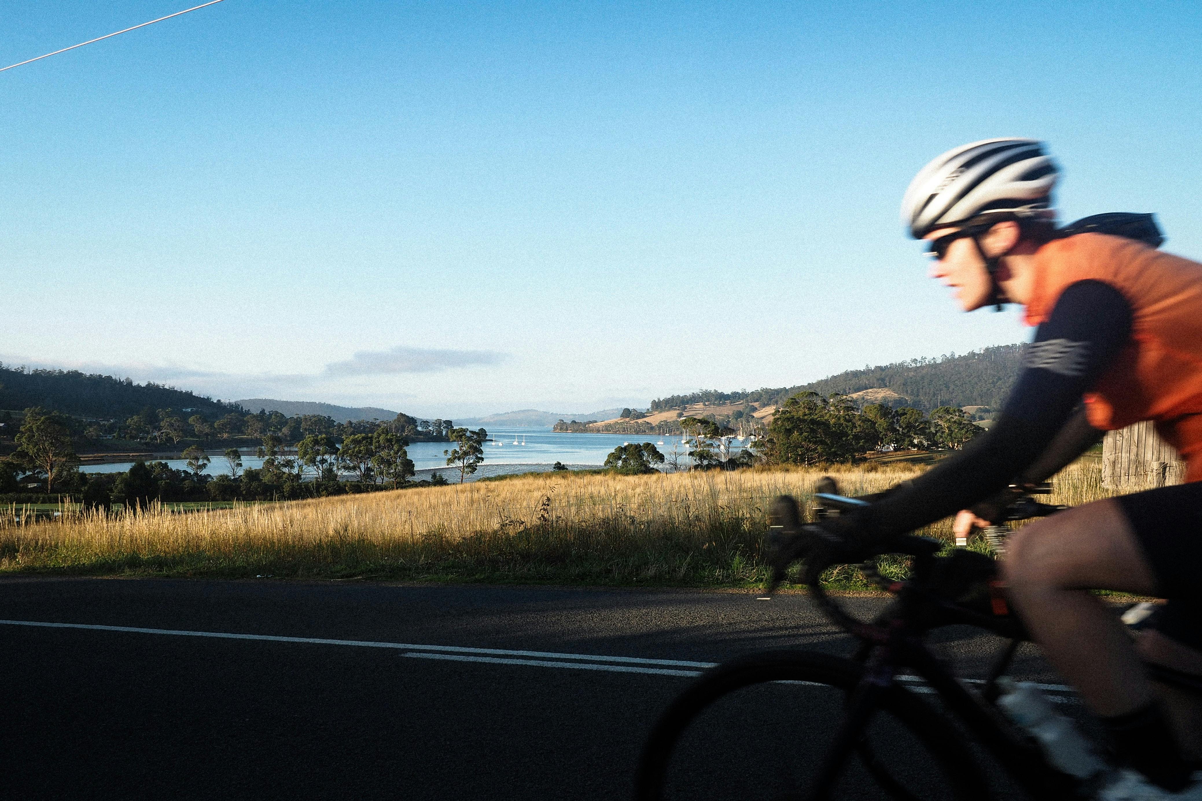 cyclist in foreground, Port Cygnet in bakcground