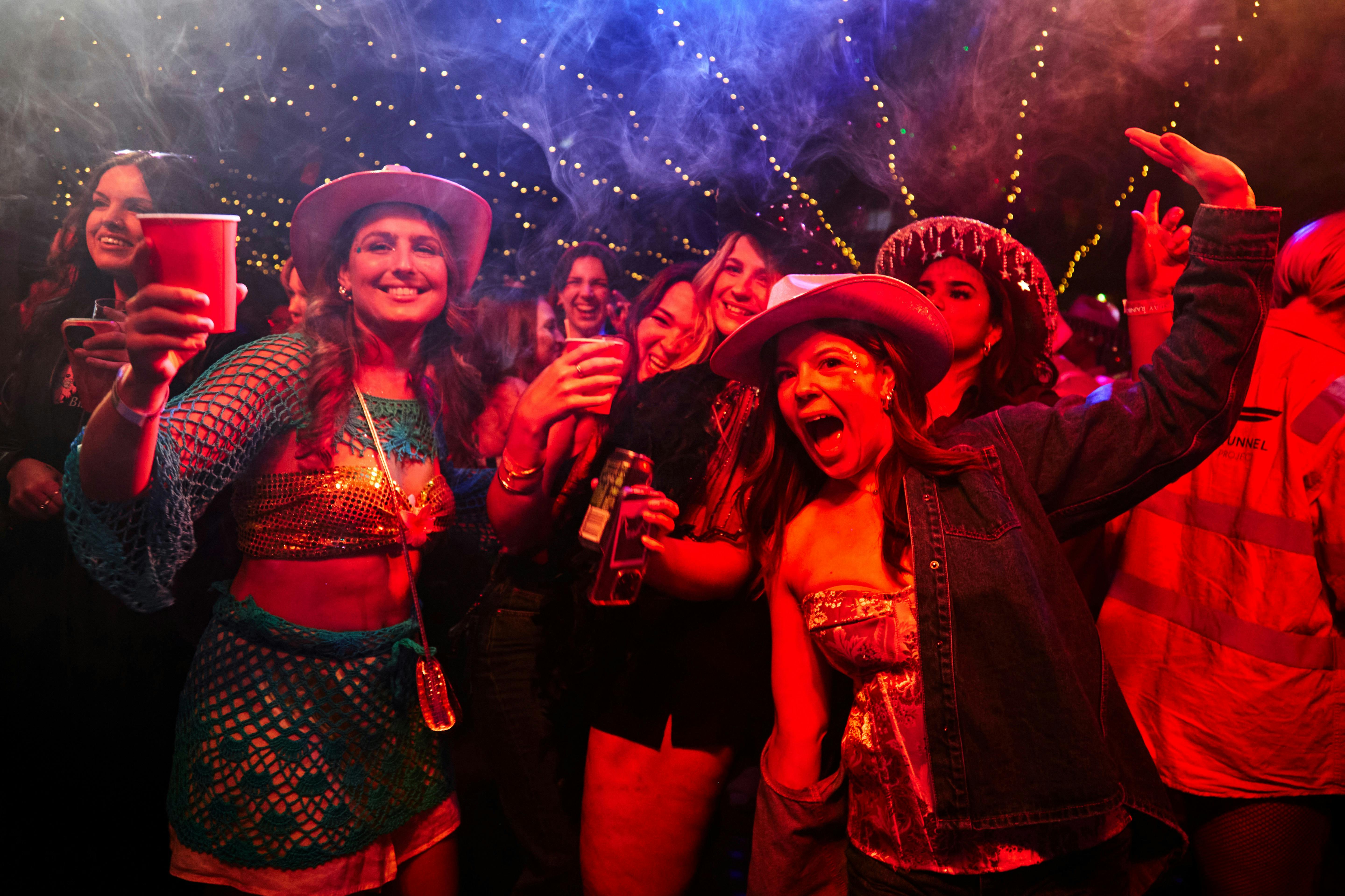 Photo of crowd enjoying the entertainment and music for rainbow fantasy party.