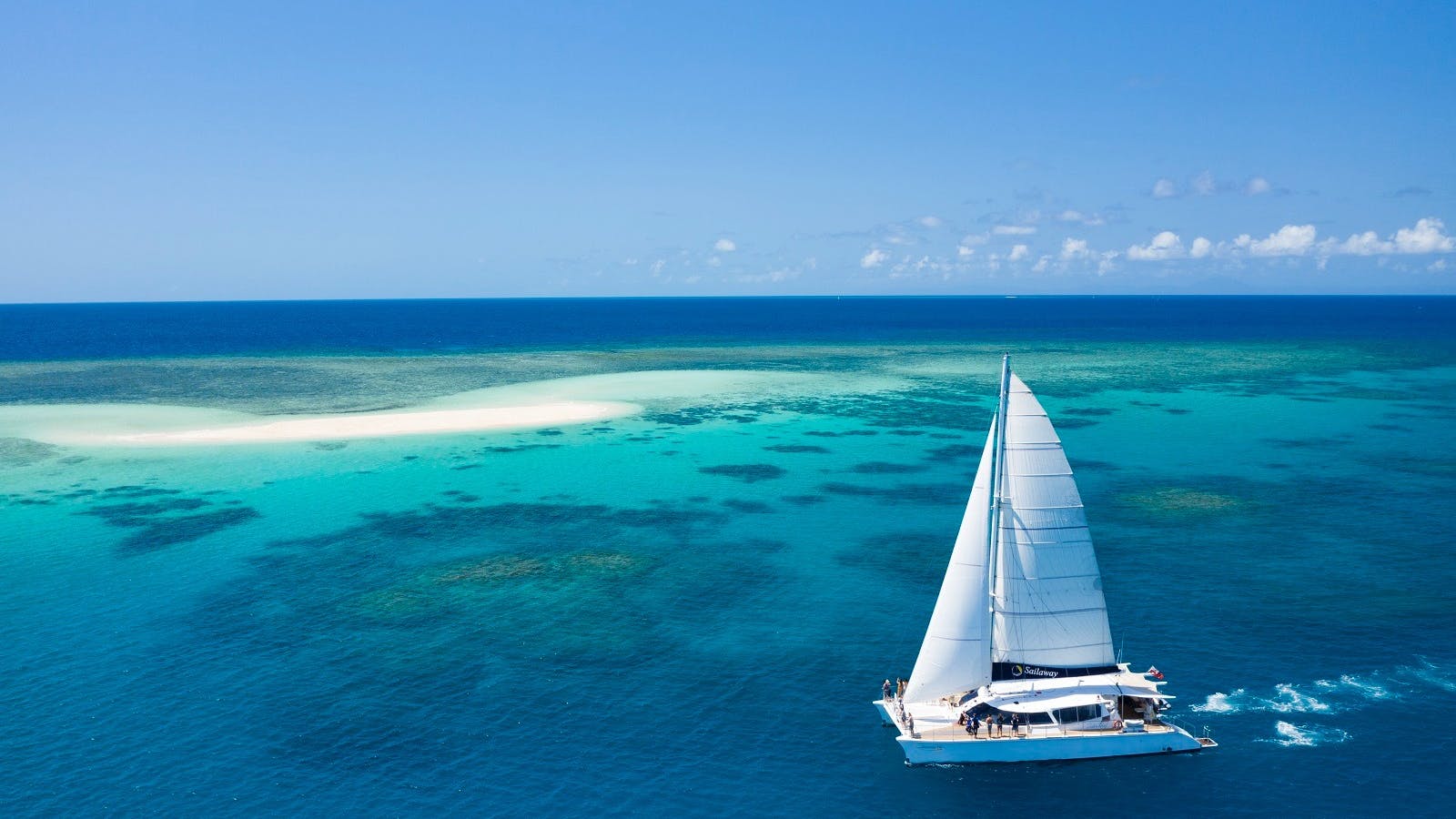 Sailaway VII in full sail with Mackay Cay as backdrop Sailaway VII in full sail with Mackay Cay as backdrop