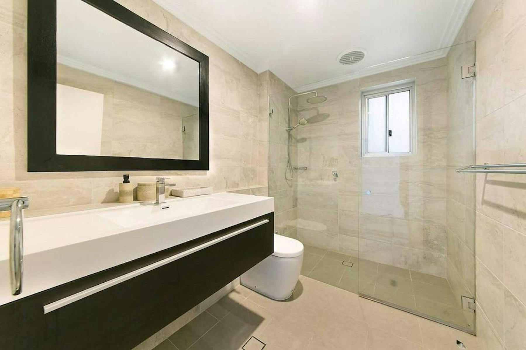 Modern bathroom with walk in waterfall shower.