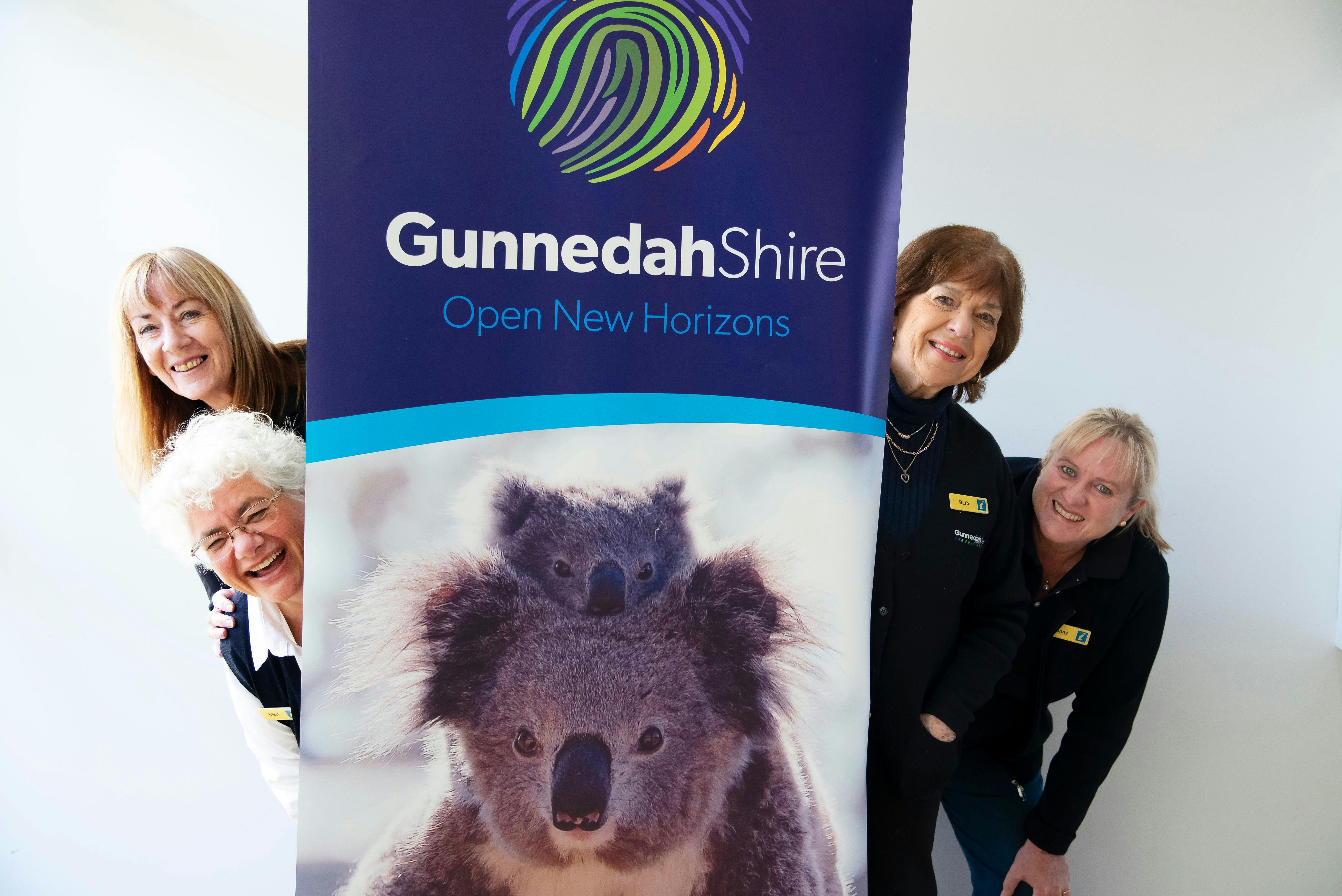 VIC team peeking out from behind Gunnedah banner