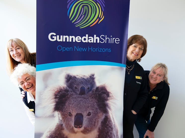 VIC team peeking out from behind Gunnedah banner