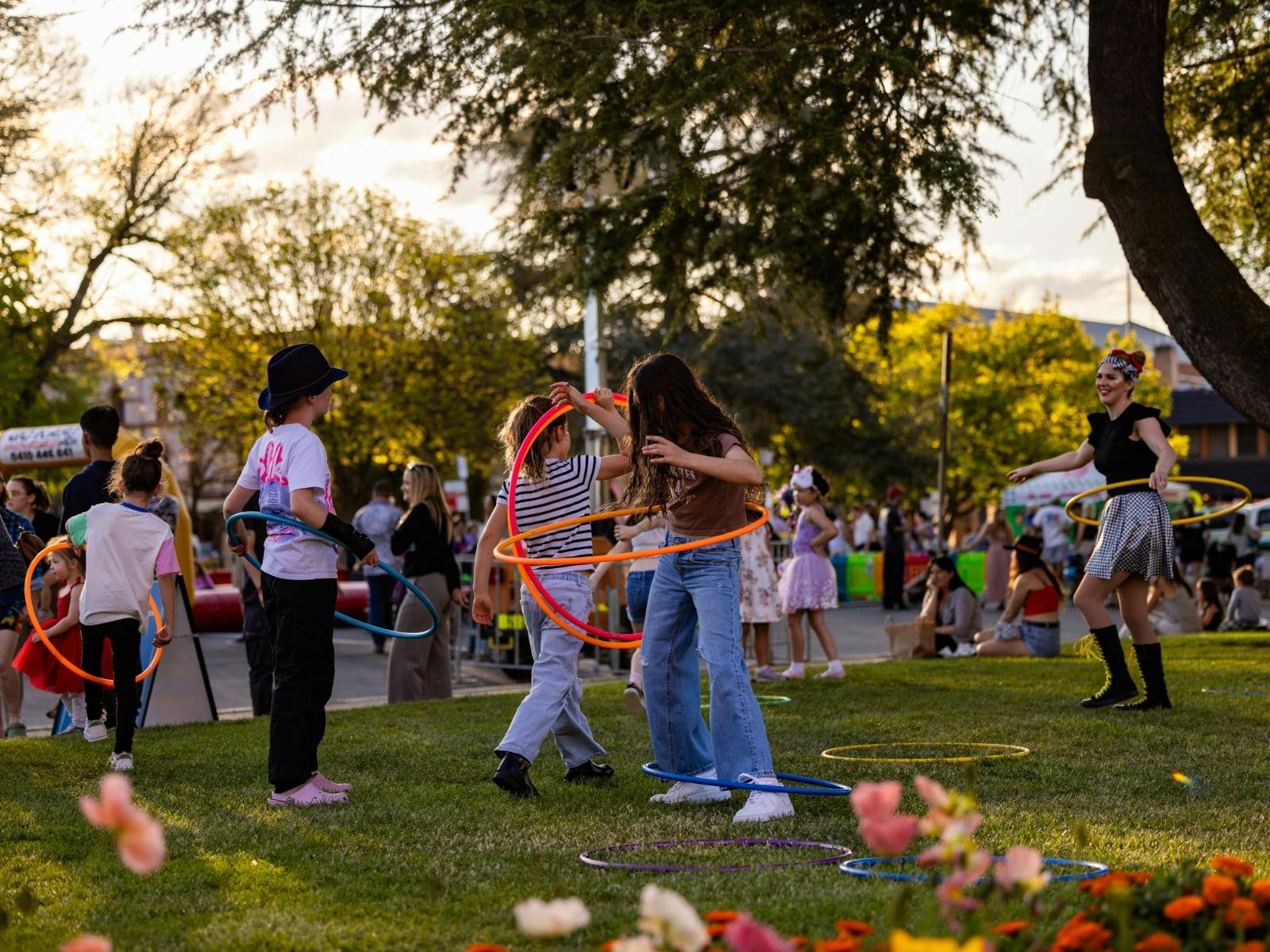 Children hoola hooping in the park.