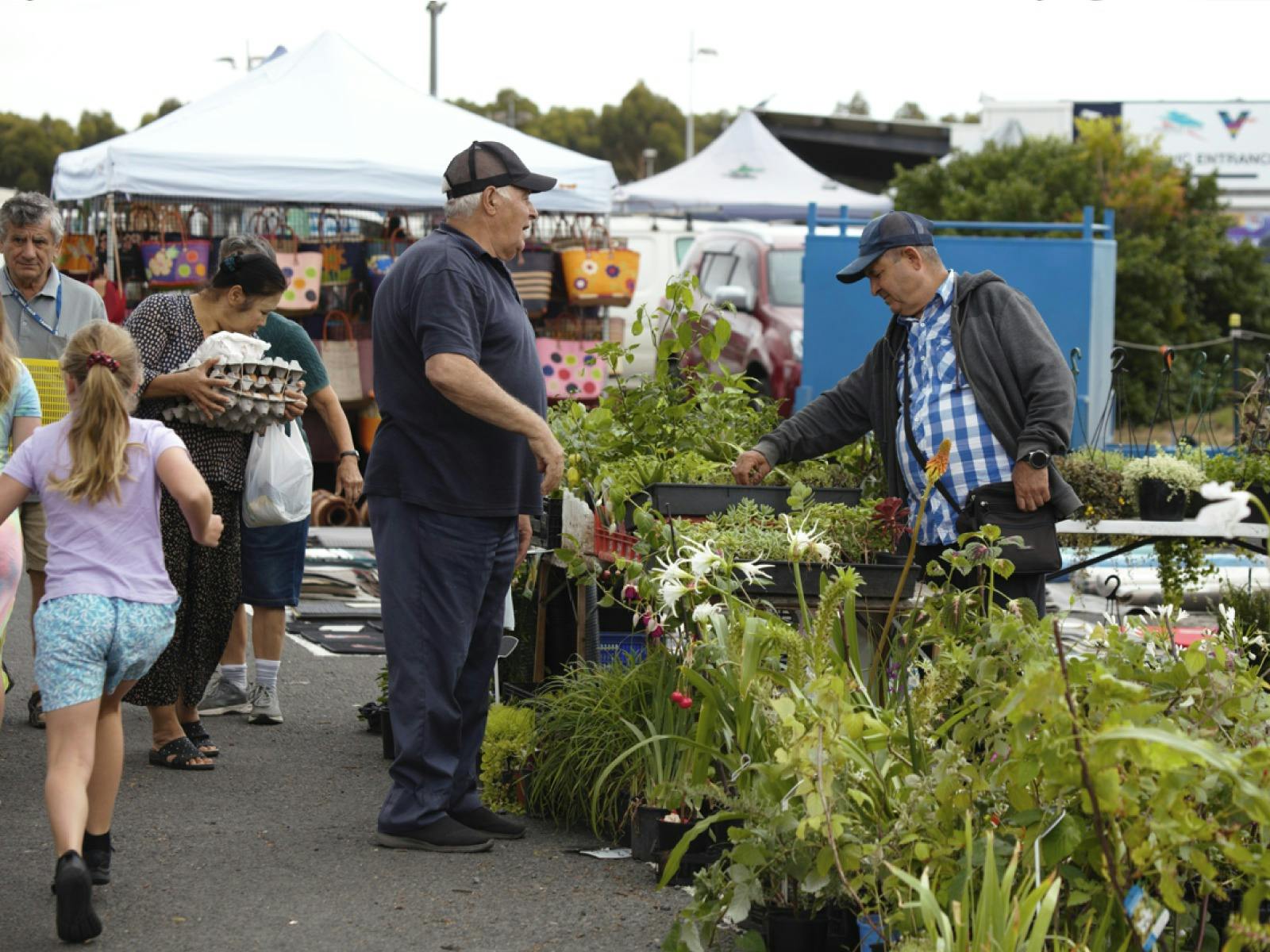 Photo of stallholders and market visitors interacting outside