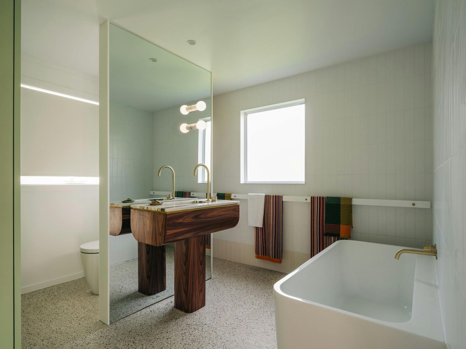 Main bathroom with bath and walk in shower.