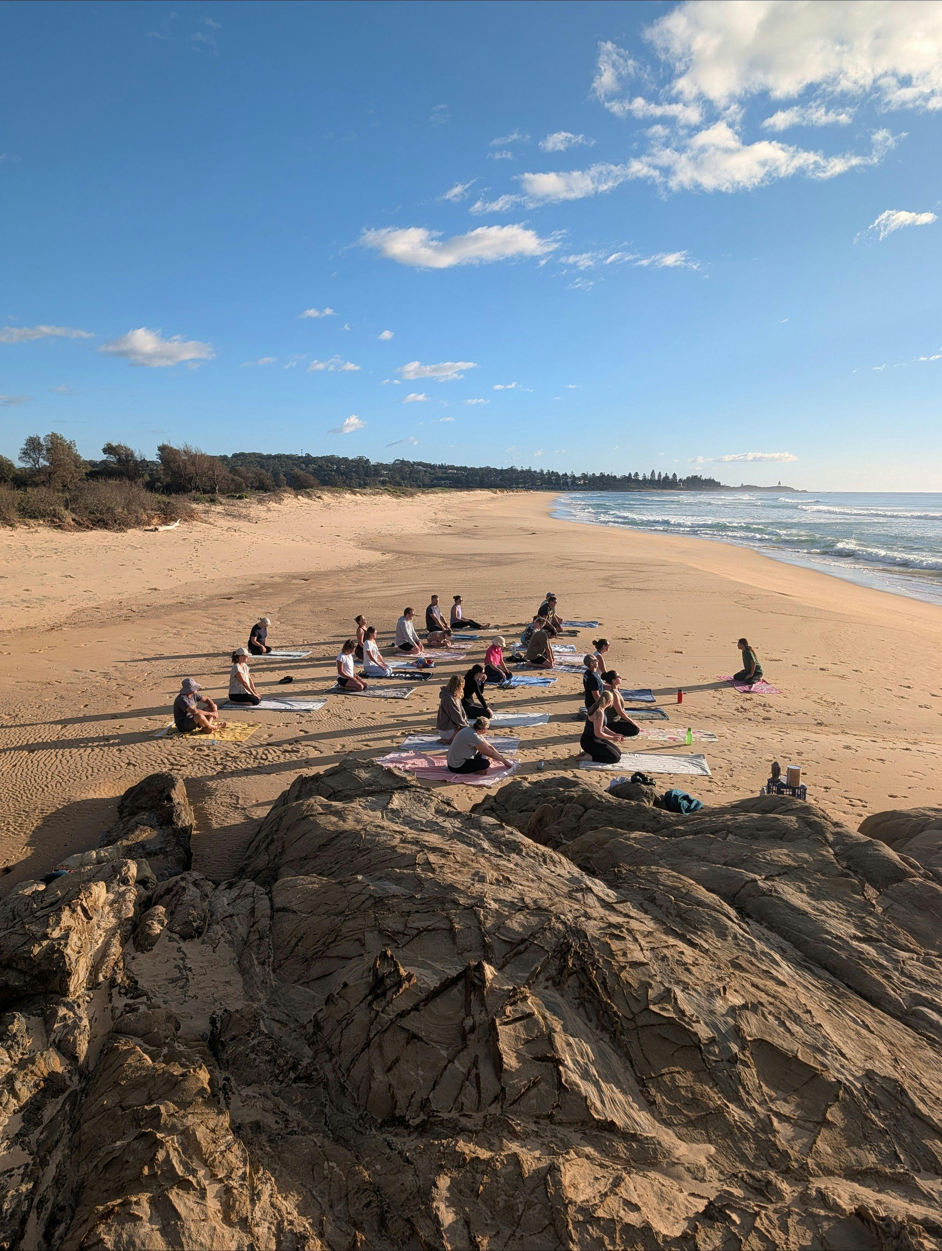 Scenic outdoor wellness class with sweeping northerly ocean views towards Tuross Head from the beach