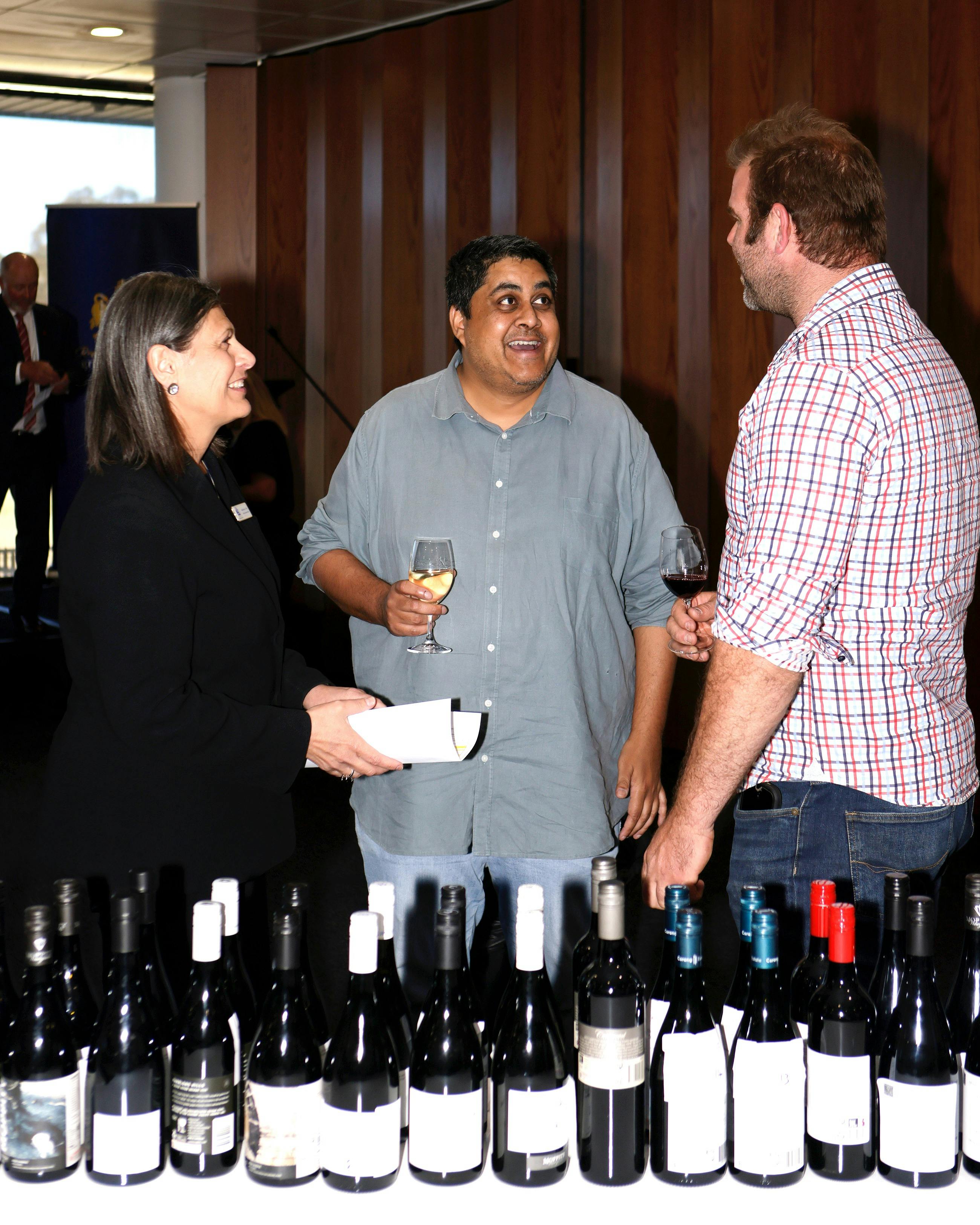 people talking and tasting wine