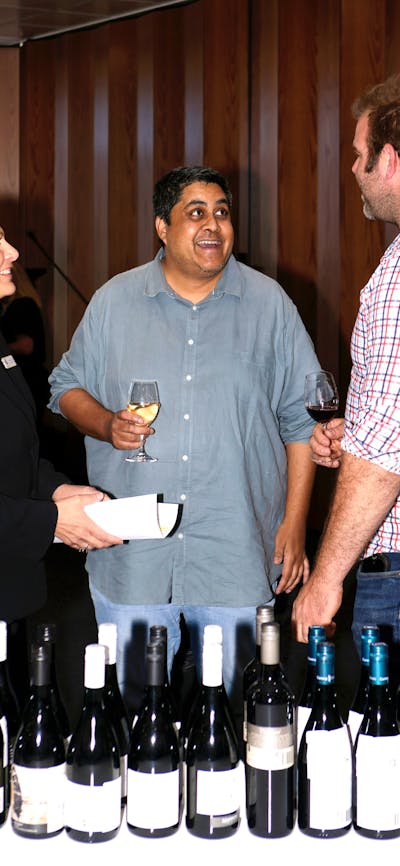 people talking and tasting wine