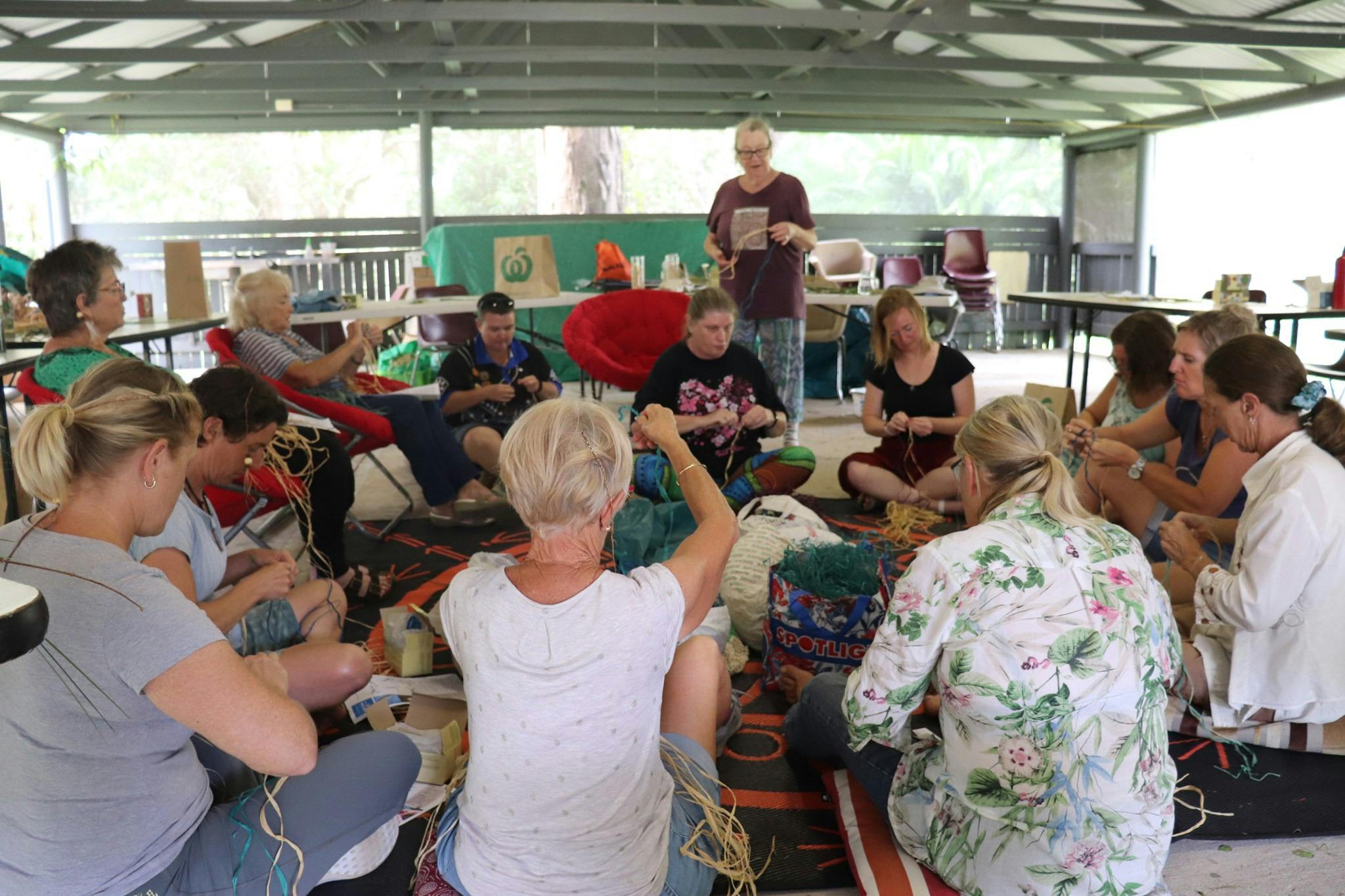 Sitting with women weaving
