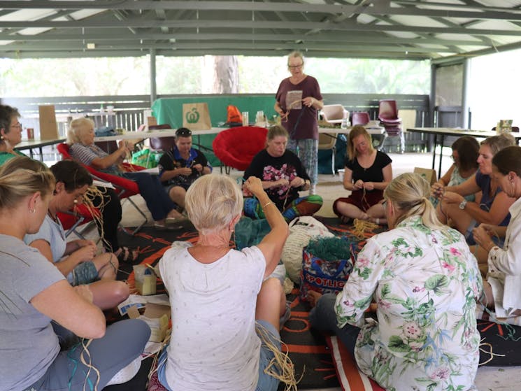 Sitting with women weaving