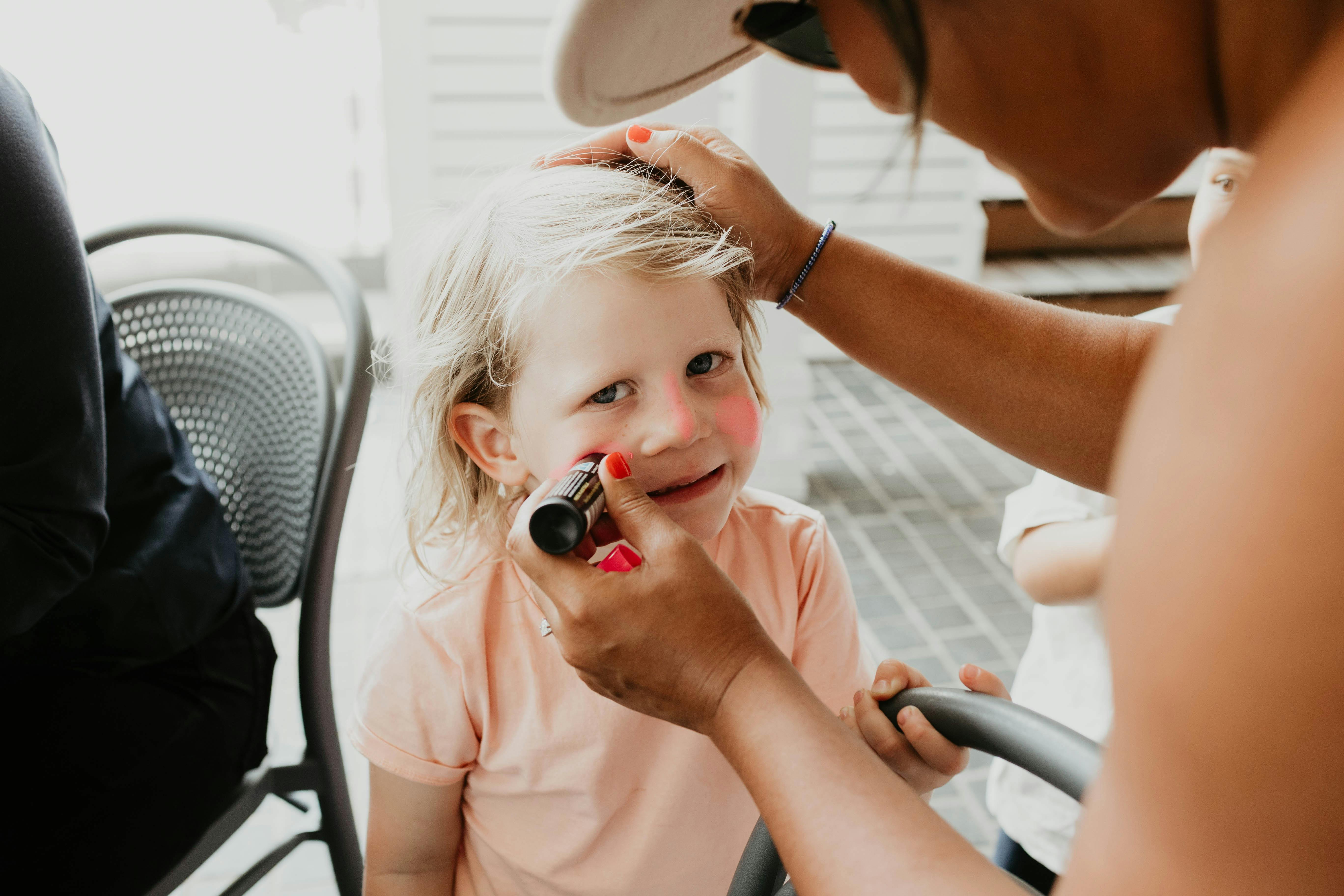 Child participating in School Holiday Funhouse with zinc face painting