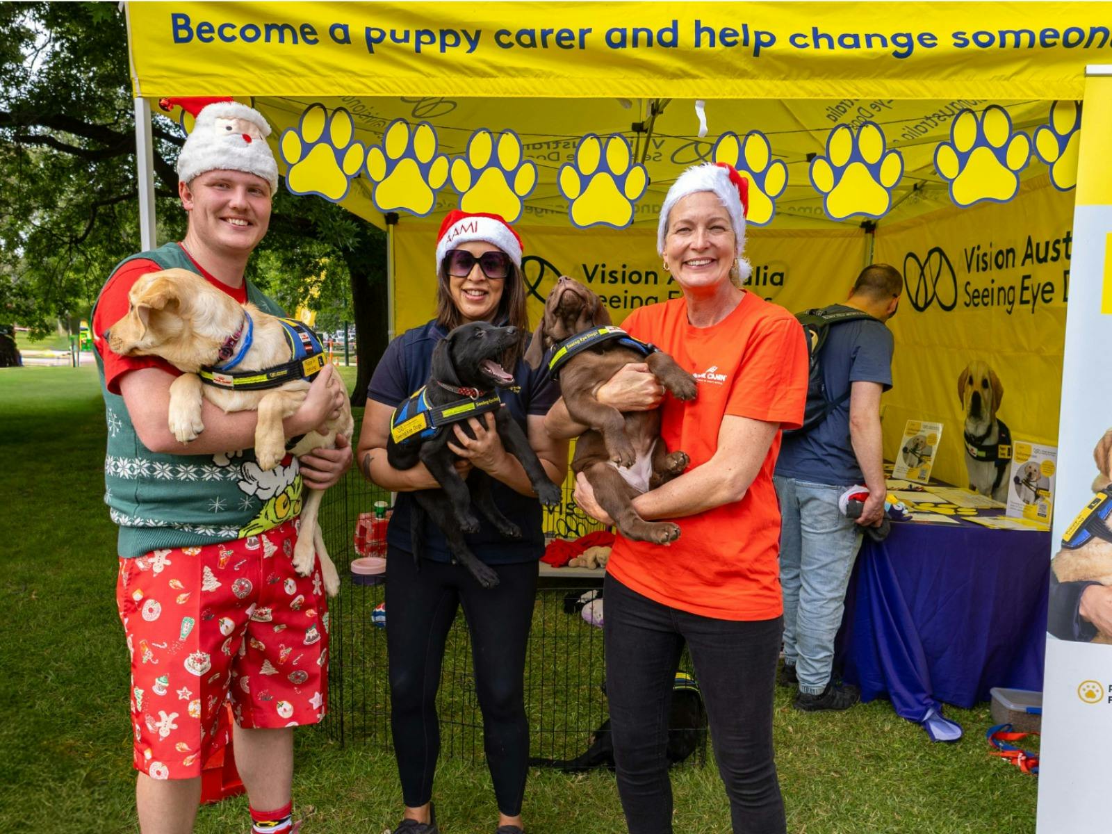 Seeing Eye Dog Staff at Santa Fun Run Cuddling Future Seeing Eye Dog Puppies