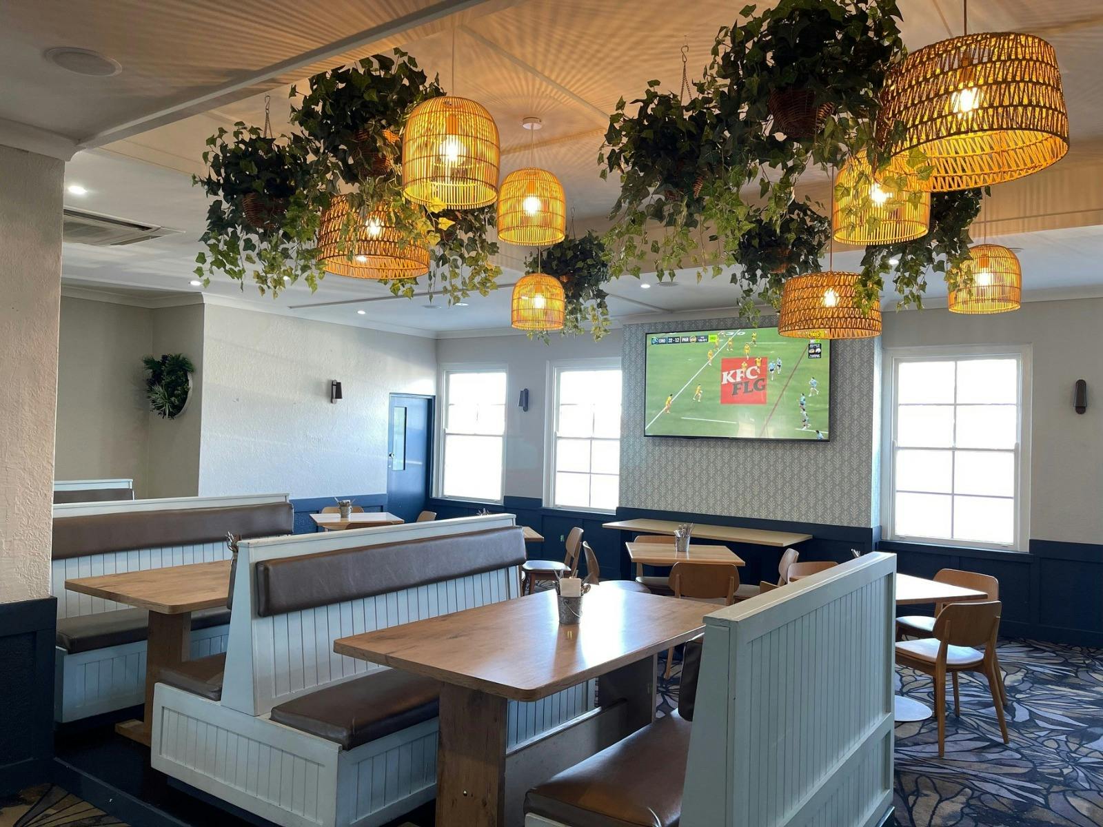 booth chairs and seating in a restaurant with a TV on the wall