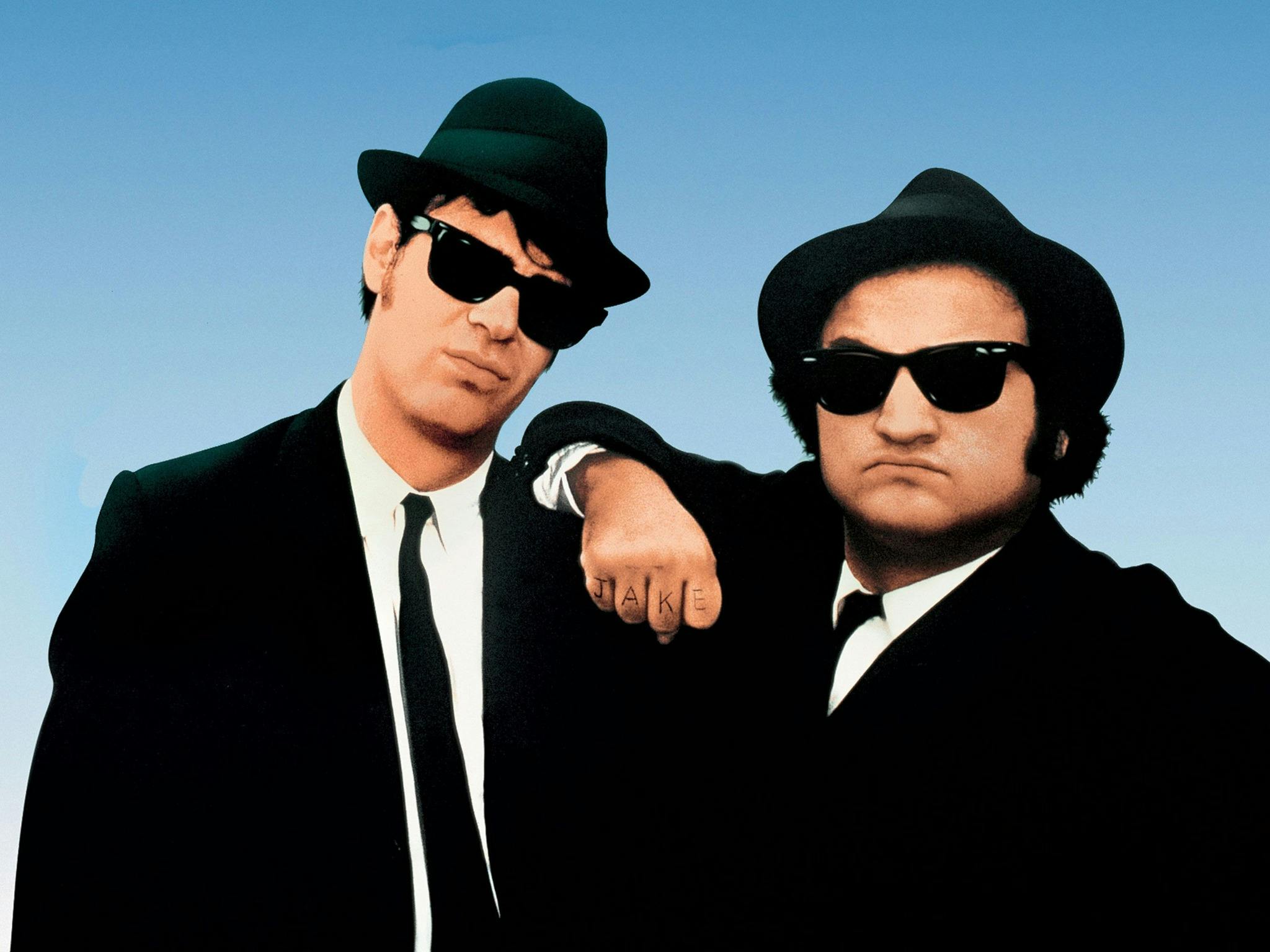 Promotional image from The Blues Brothers showing two men in dark suits and sunglasses